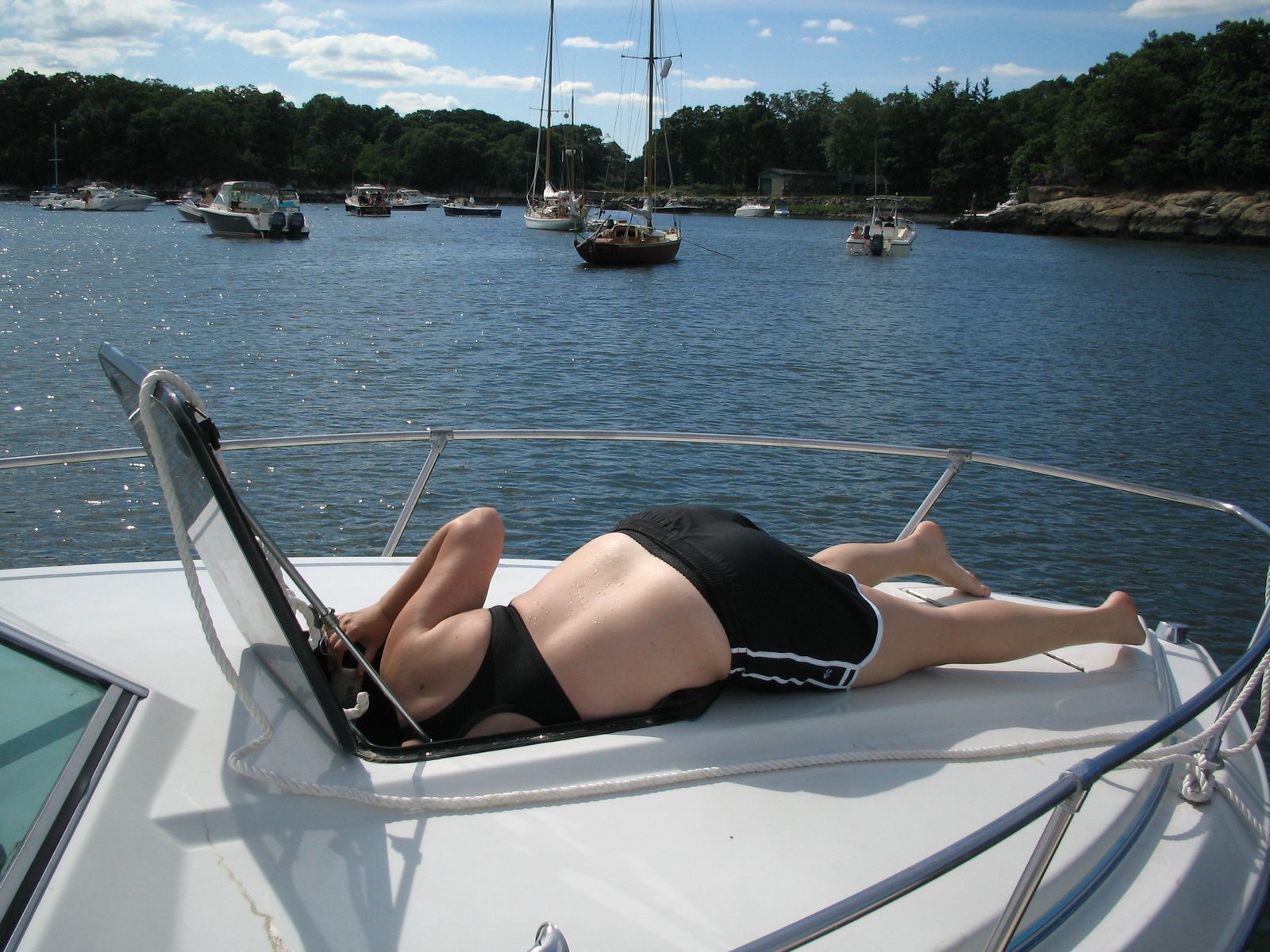 Catherine finding something below deck on a fine day on Long Island Sound.