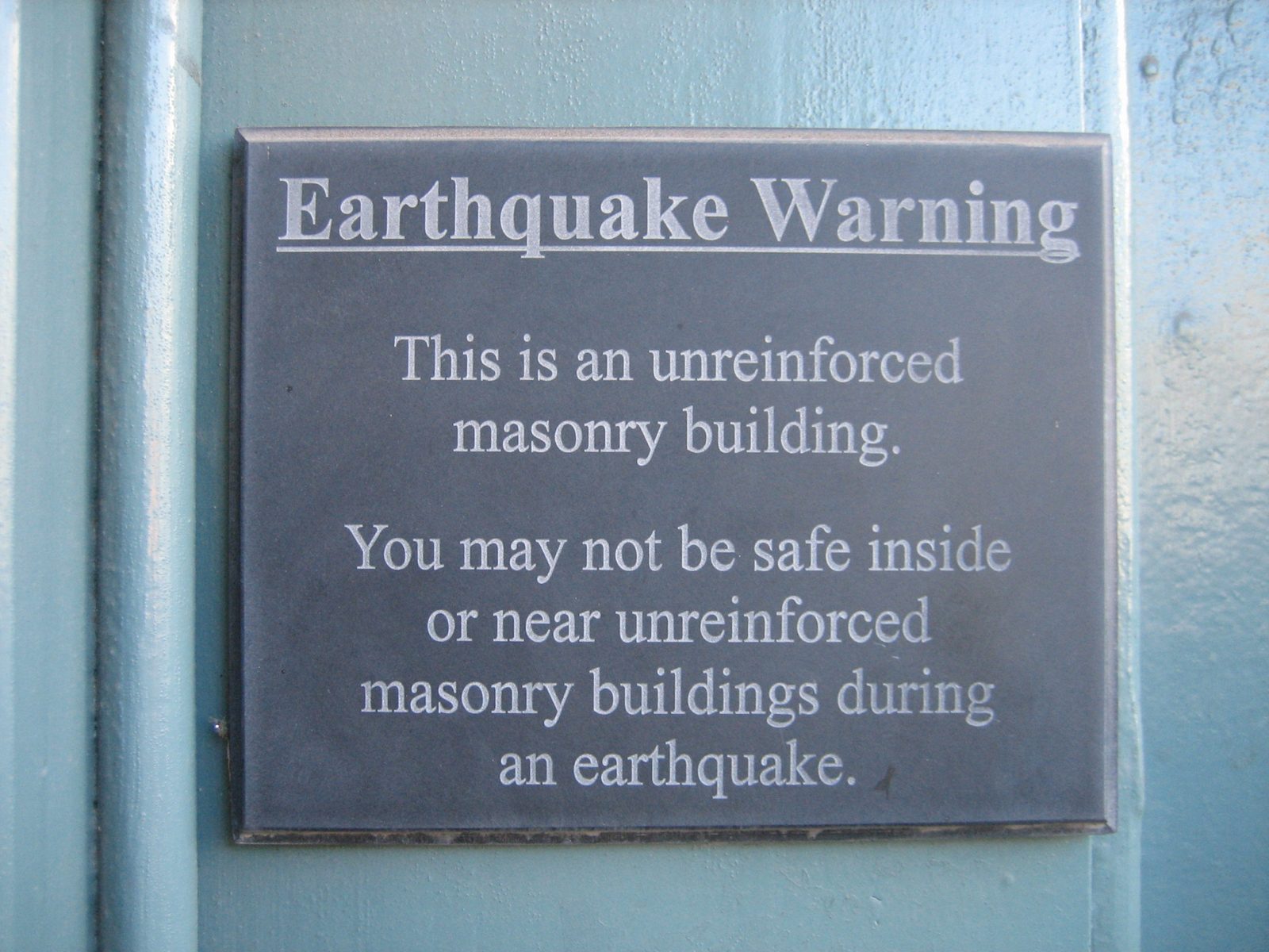 Awesome warning sign near the door to a fancy home furnishing store.