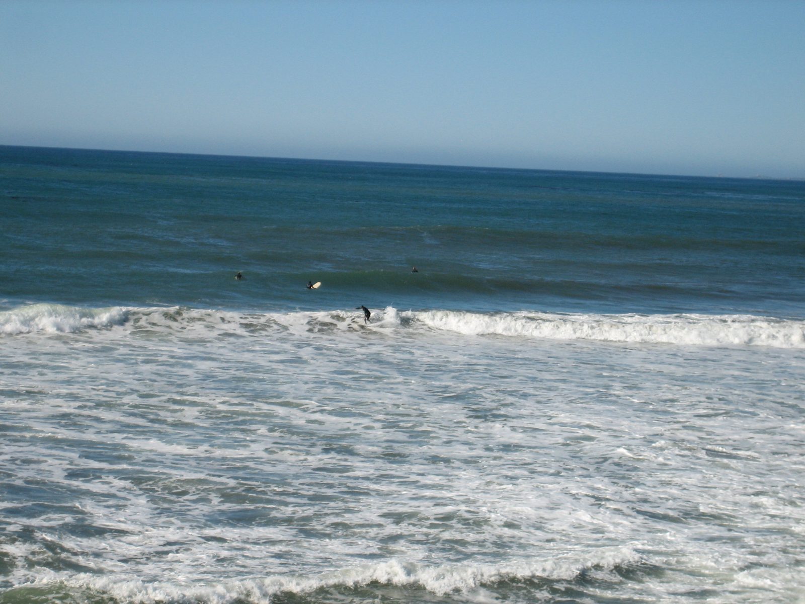 A surfer finishes a ride in.