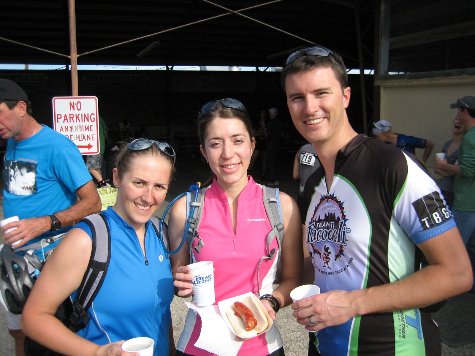 Three riders at the end of the day, refueling with sausage and beer.