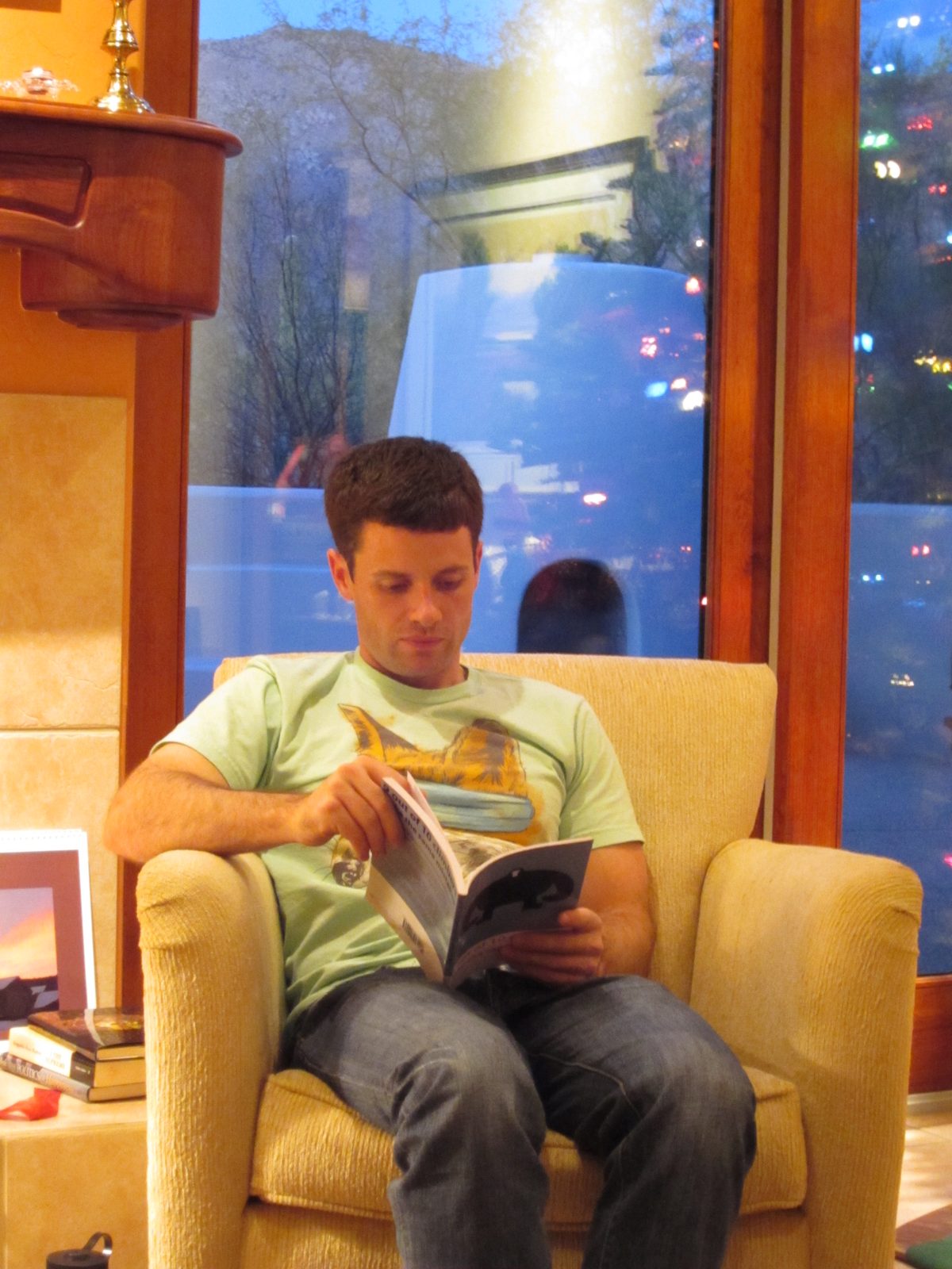 Jay reads Christmas evening, with the Catalina Mountains behind him.