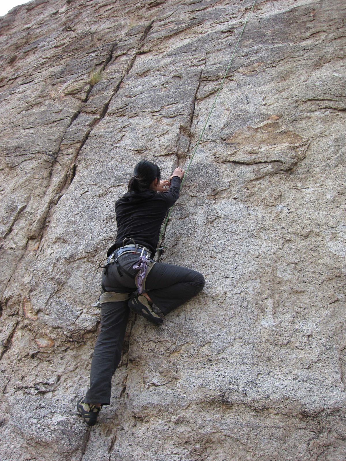 Monica starts up a route on Left Wall, at the Hairpin Turn climbing area of Mt. Lemmon.