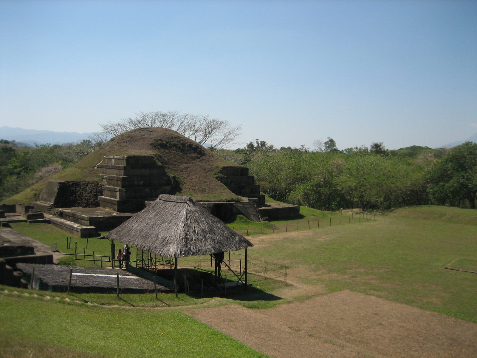 Looking at the biggest of the buildings, mainly covered under grass.  Under the hut in the...
