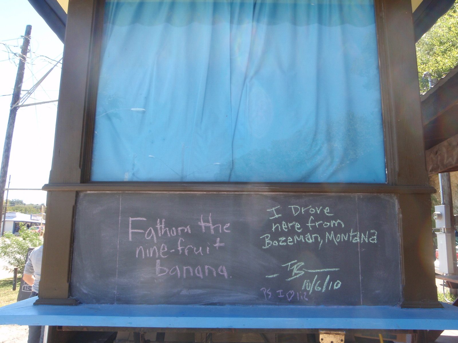 Chalk board with messages on the side of the Bananarchy stand.