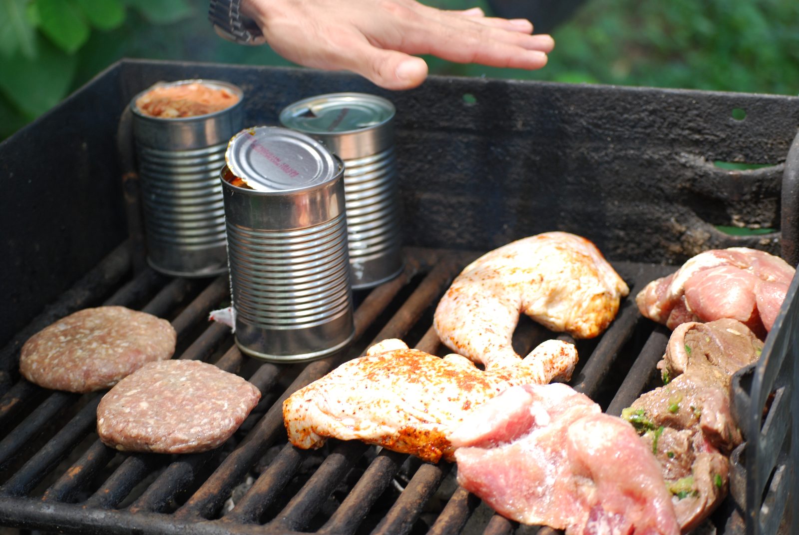 Lunch meats and beans cooking on the stove.