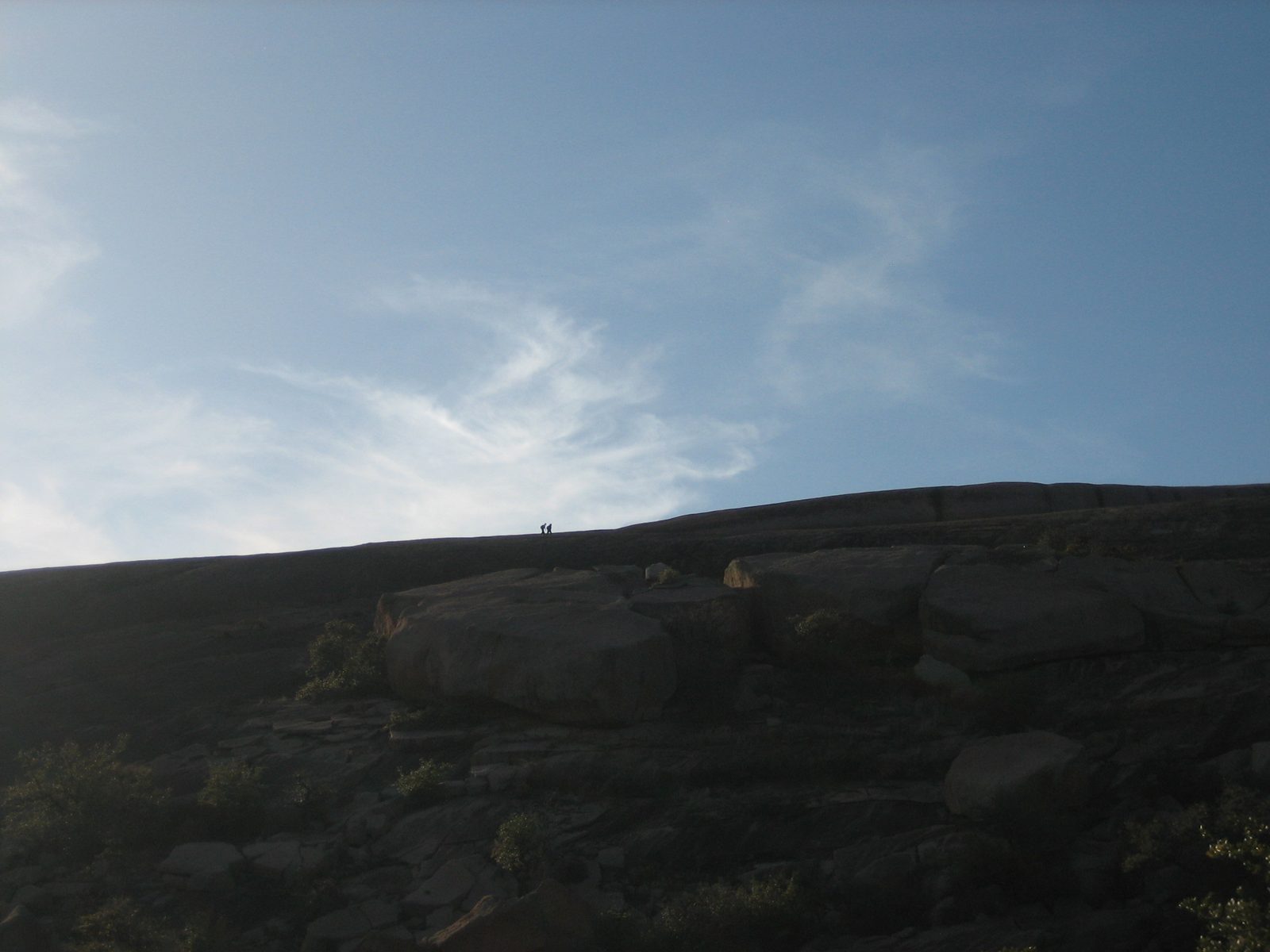 Looking at the top of E-Rock from the path to Turkey Peak, with some hikers visible.