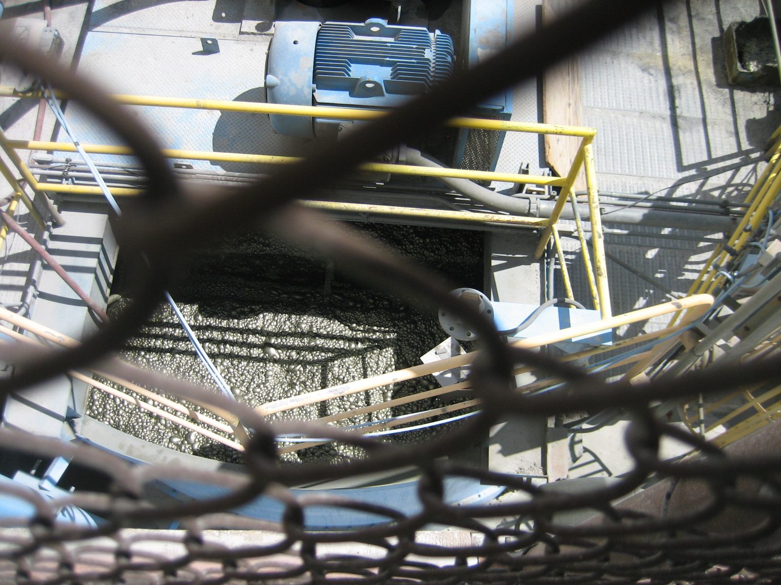 Looking through the cage of the bridge at the copper bubbles below.