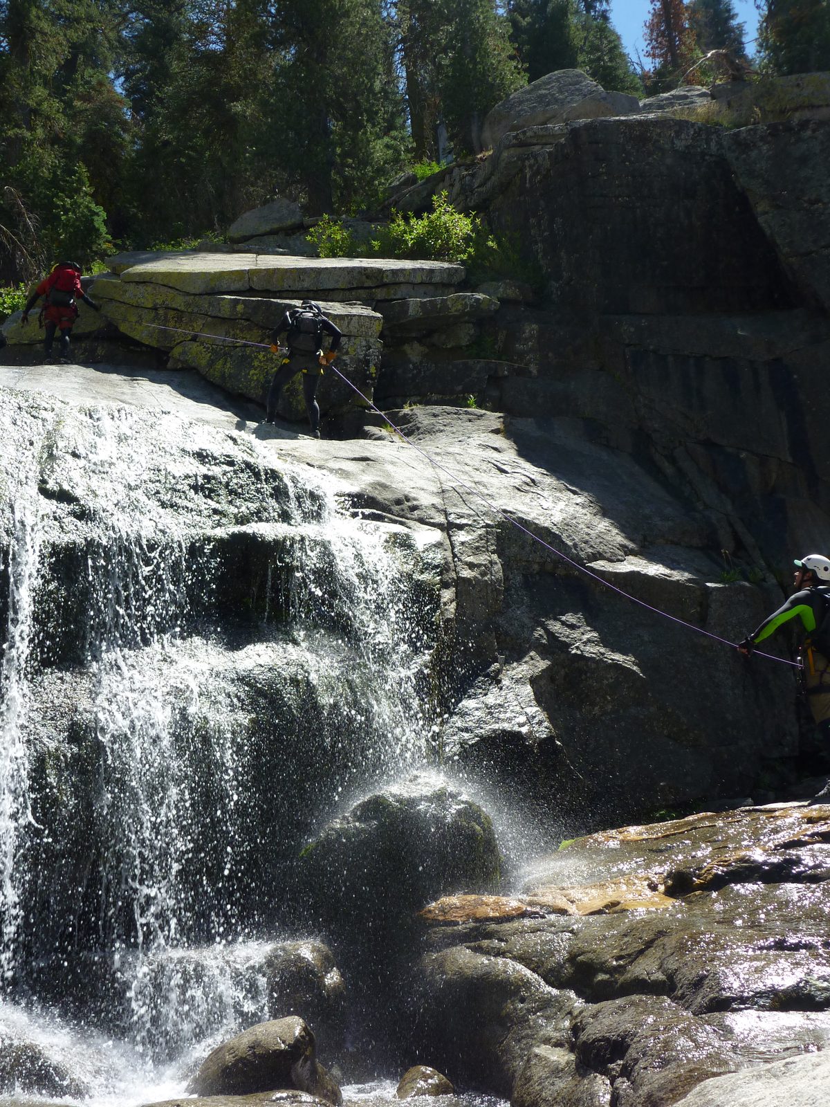 Tommer on rappel, with Jon providing a fireman's belay.  John is above.