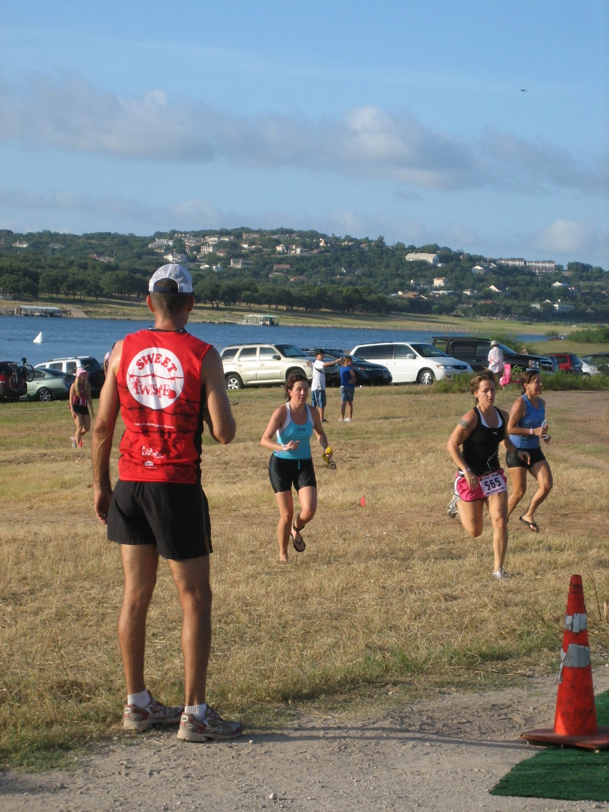 Susan comes out of the swim - she is in black shorts and blue and white shirt.