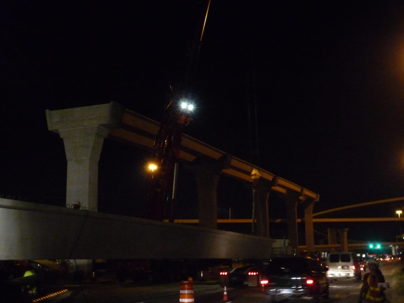 What followed was an intricate series of moves by two cranes to get the beam from one side of...