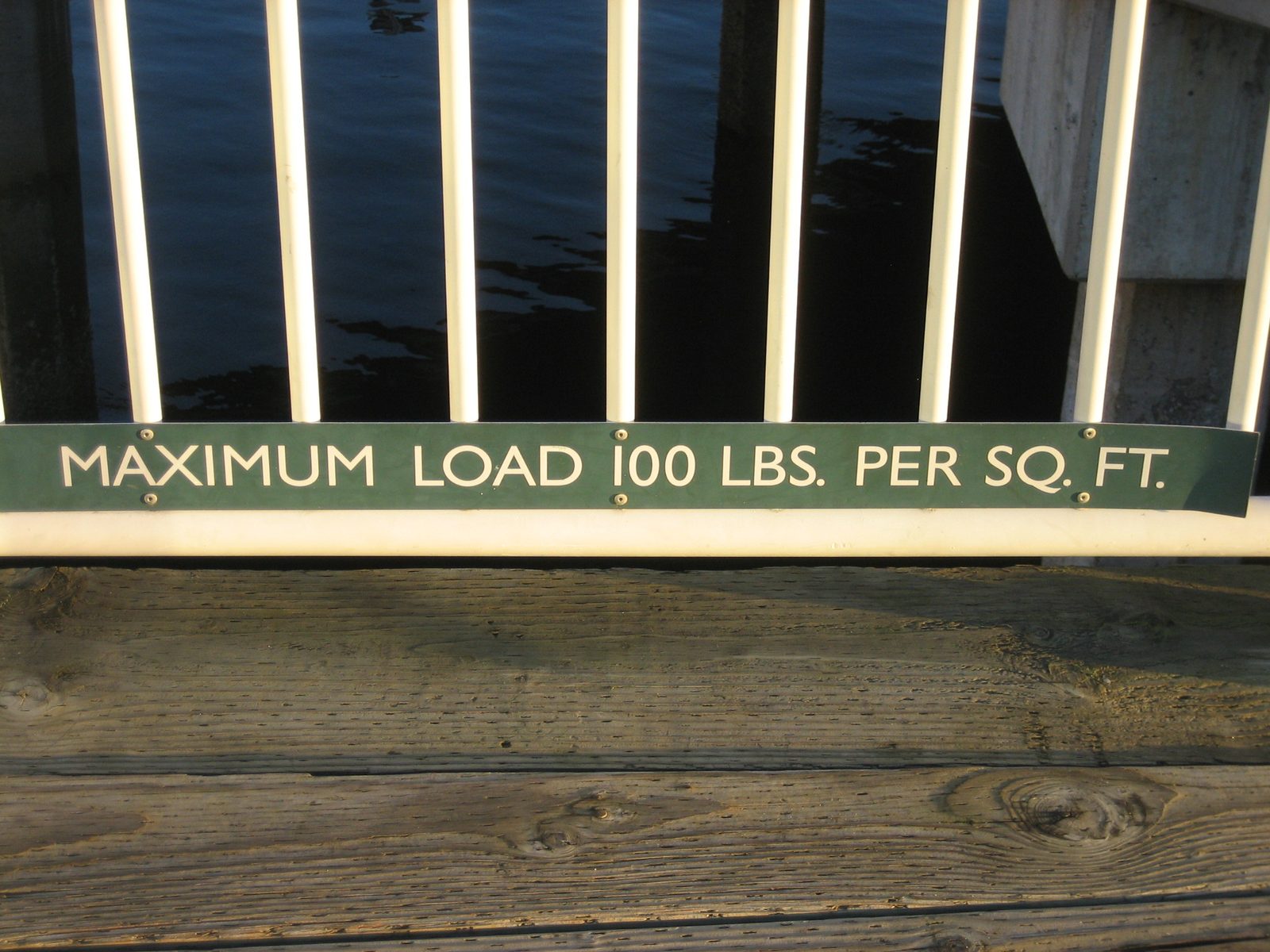A sign on a waterfront pier.