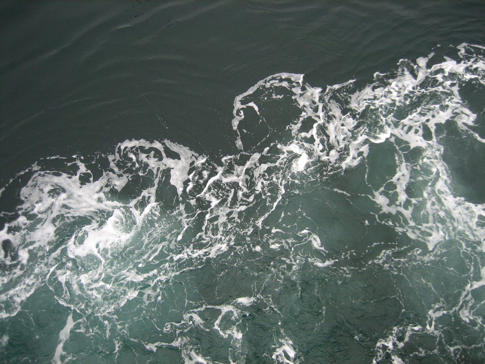 Desktop background of water churning near the hull of the ferry.