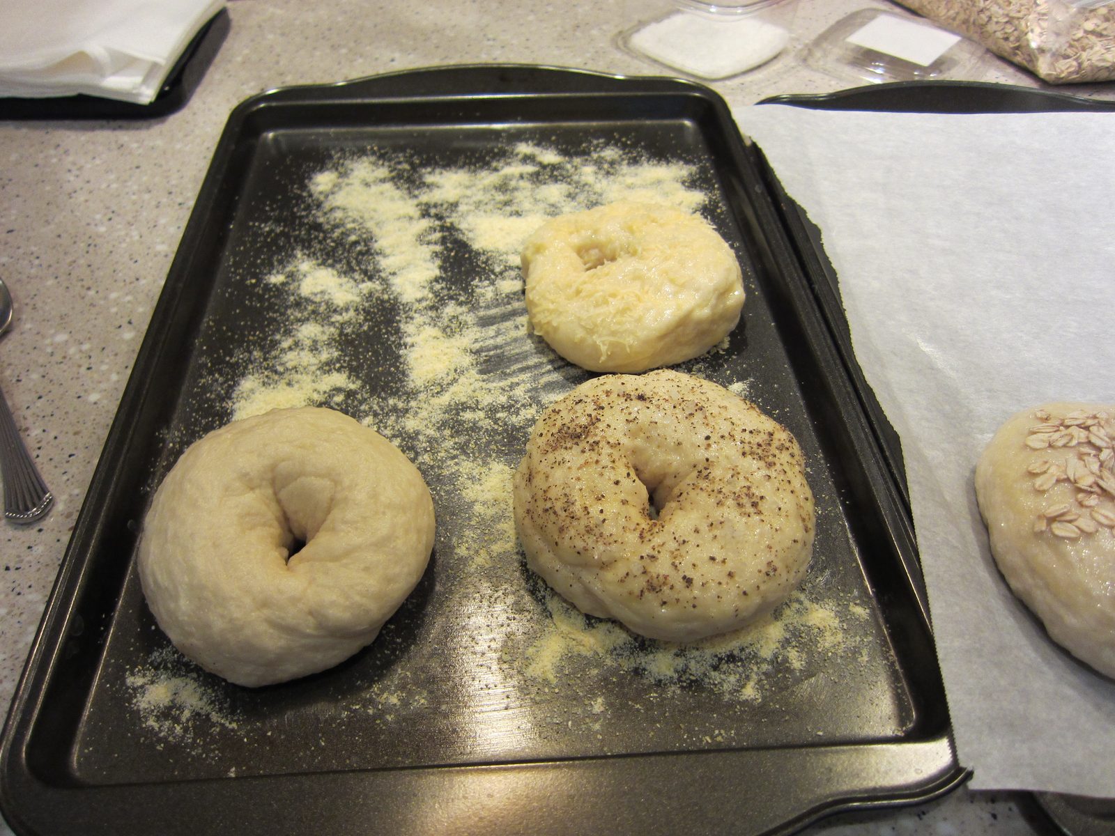 I believe there is a plane, salt-and-pepper, and asiago cheese bagel on the left, and an oatmeal...