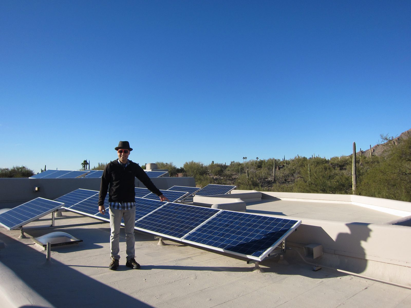 John points at the solar panels on the roof during the 2011 Solar Power Tour.