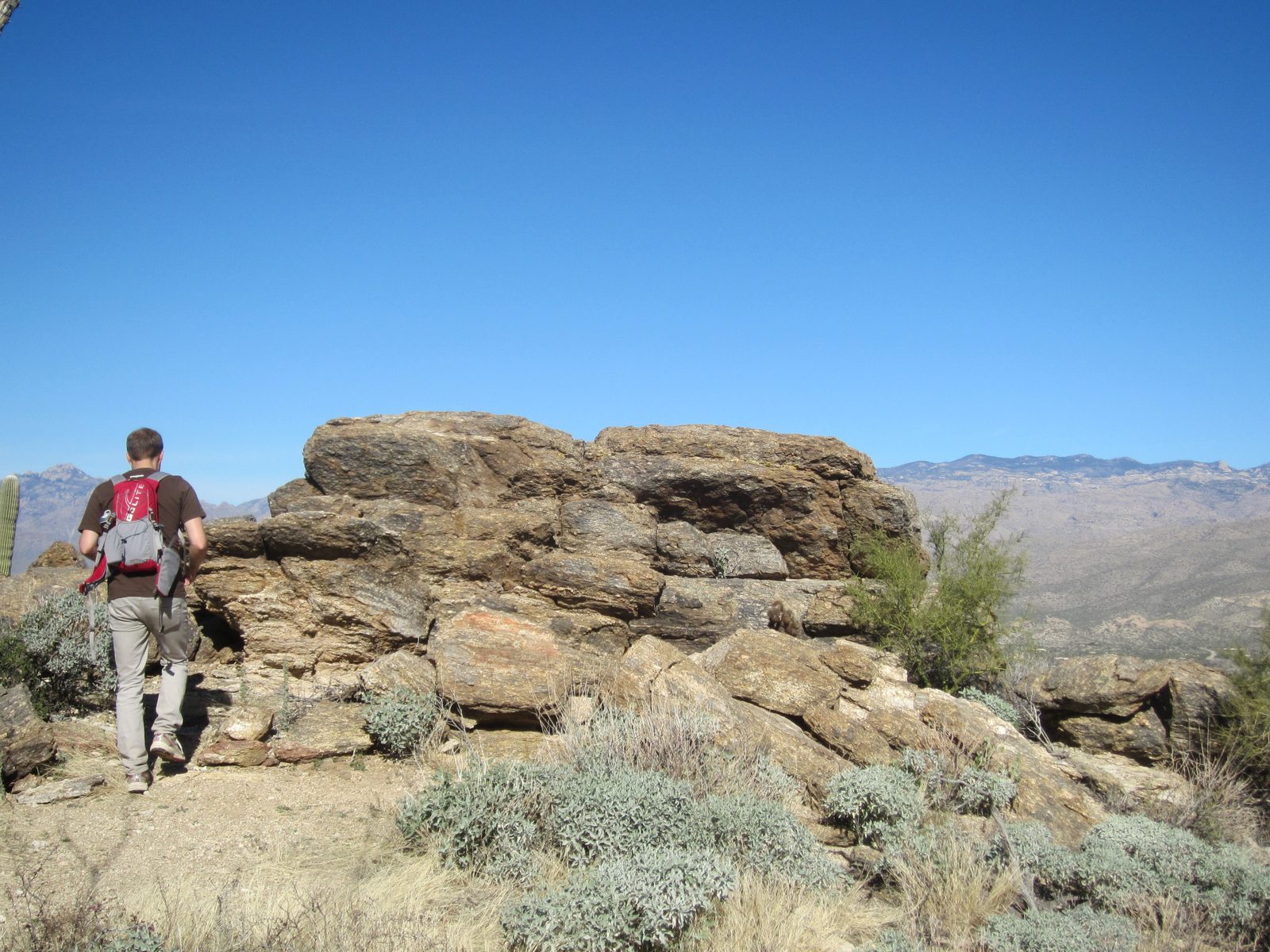 John hikes up to some rocks made of what Dad thought was Arizona Granite (if I am remembering right).