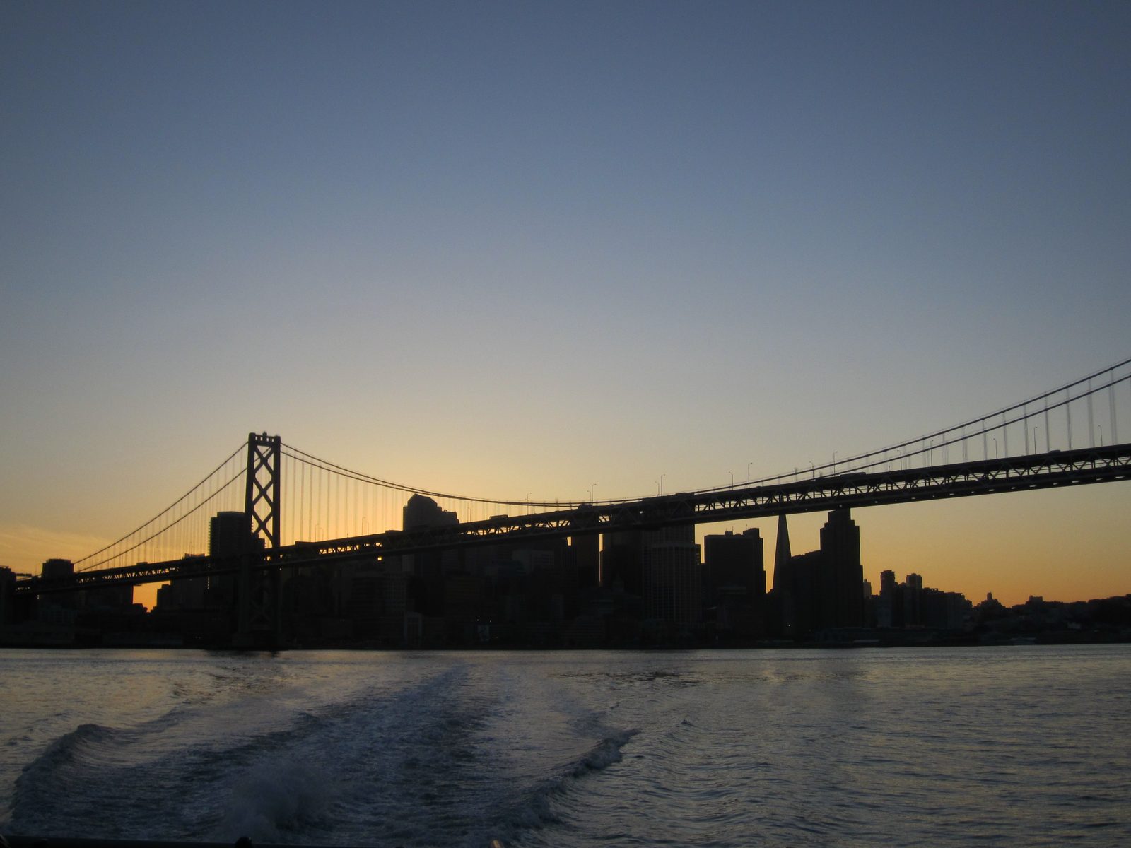 Looking back at the city over the wake and through the bridge.