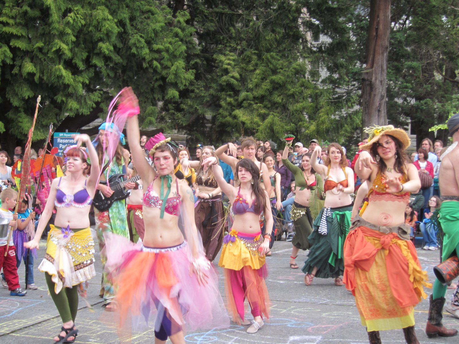 These ladies... belly-danced? in bras and crepe-paper skirts.