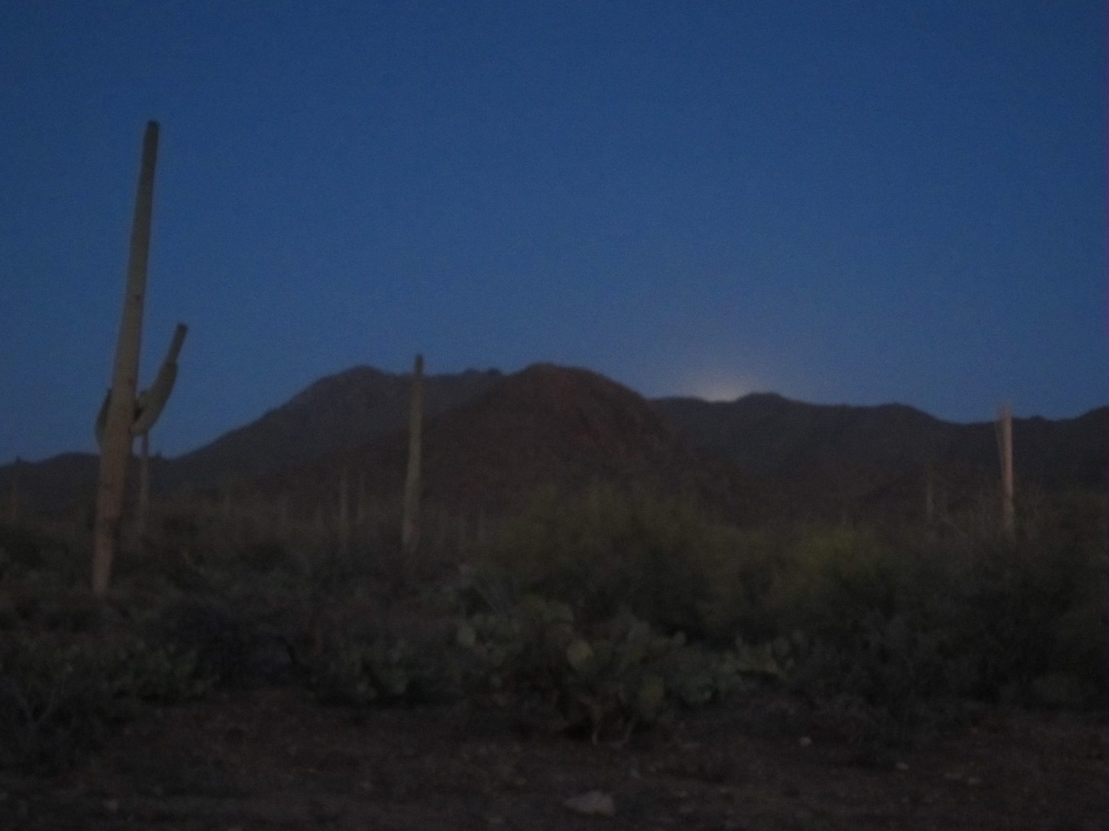 The supermoon starts to rise over the mountains.  The only flaw in our plan was that the moon...