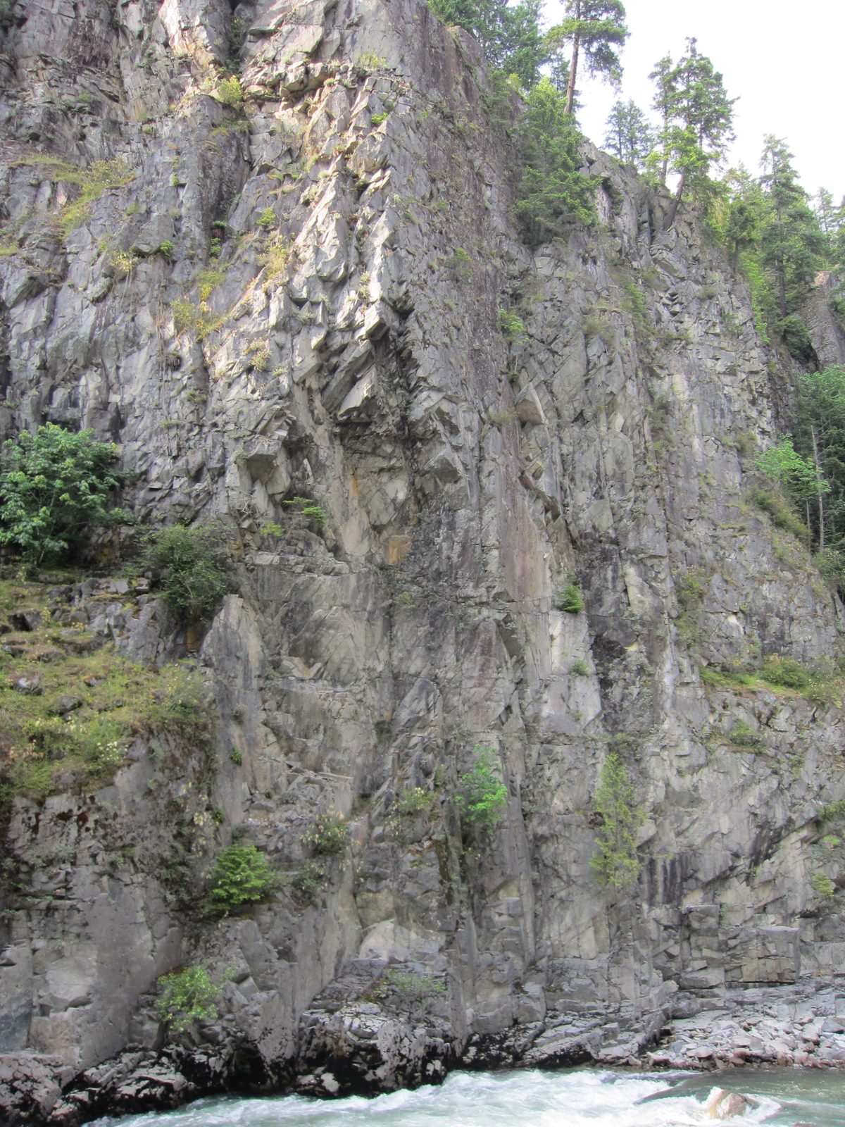 Rock wall on the far side of the river.