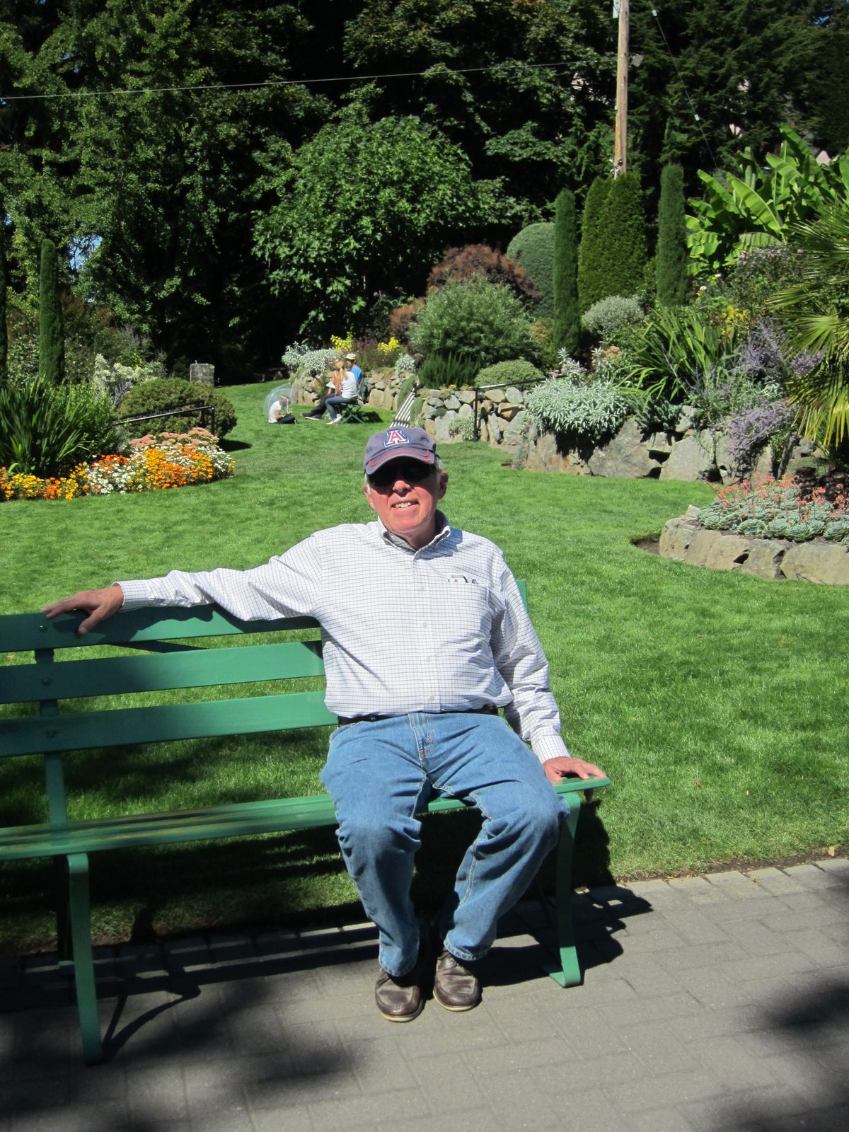 Dad sits outside the Butchart Gardens, waiting for the group to assemble.