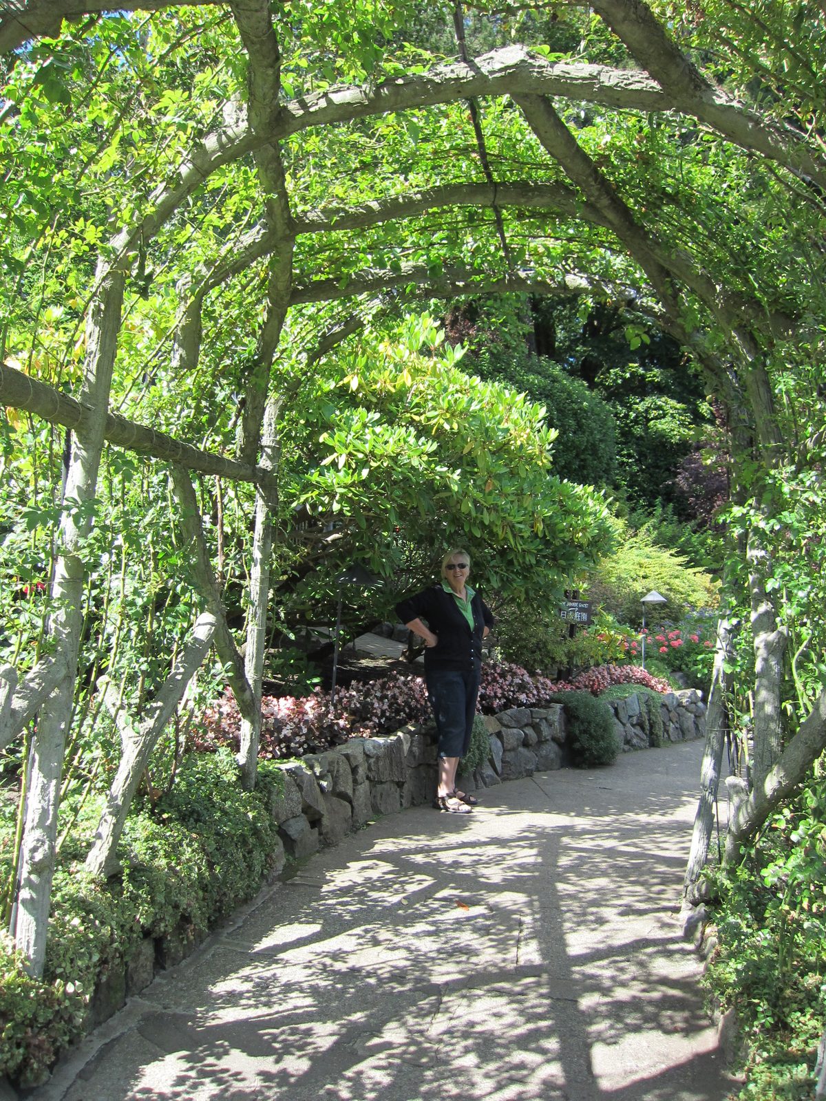 Mom poses at the end of an arbor (is that the right word? Trellis? Help!).