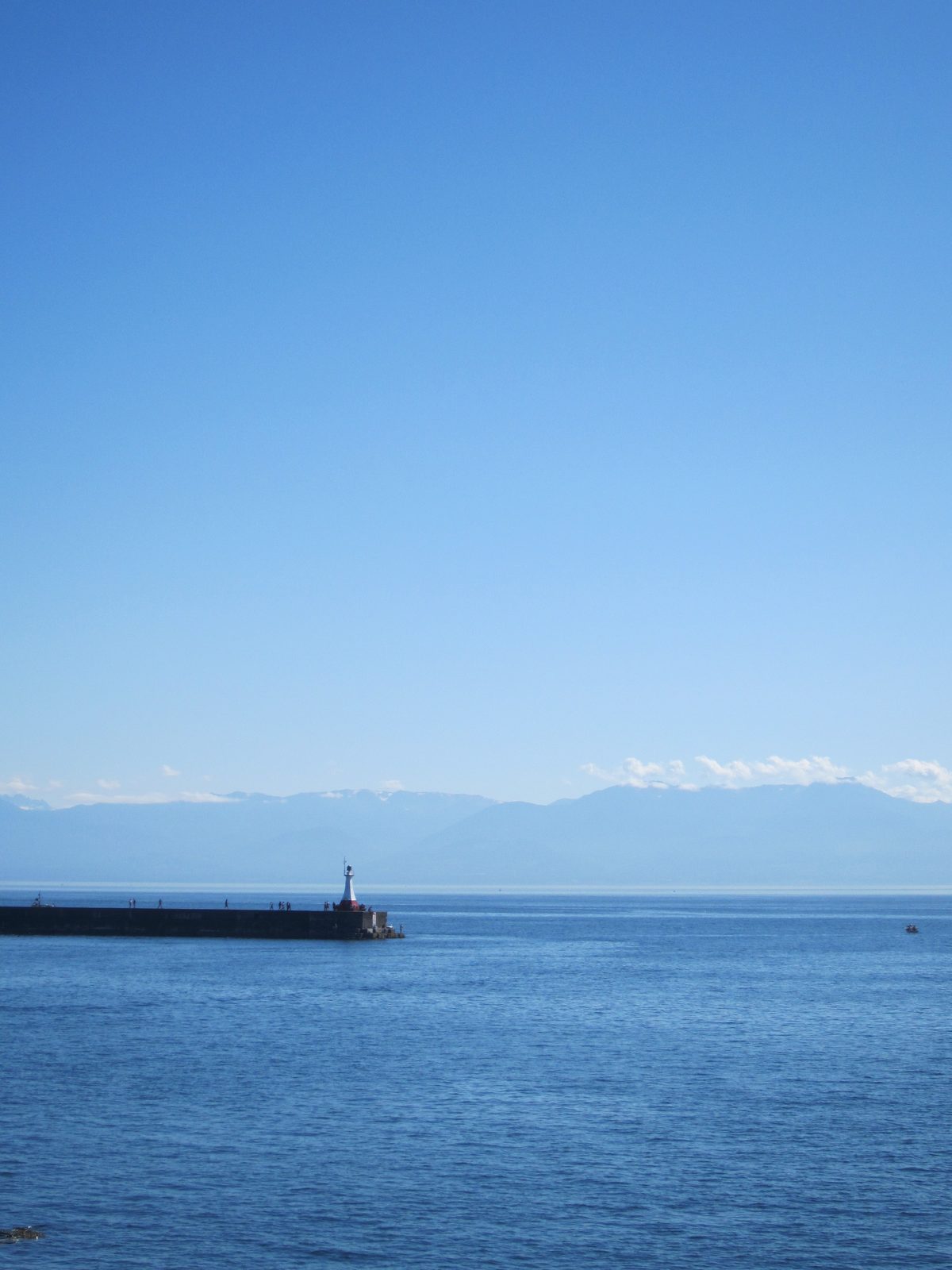 A final shot of a lighthouse in Canada and mountains in America.