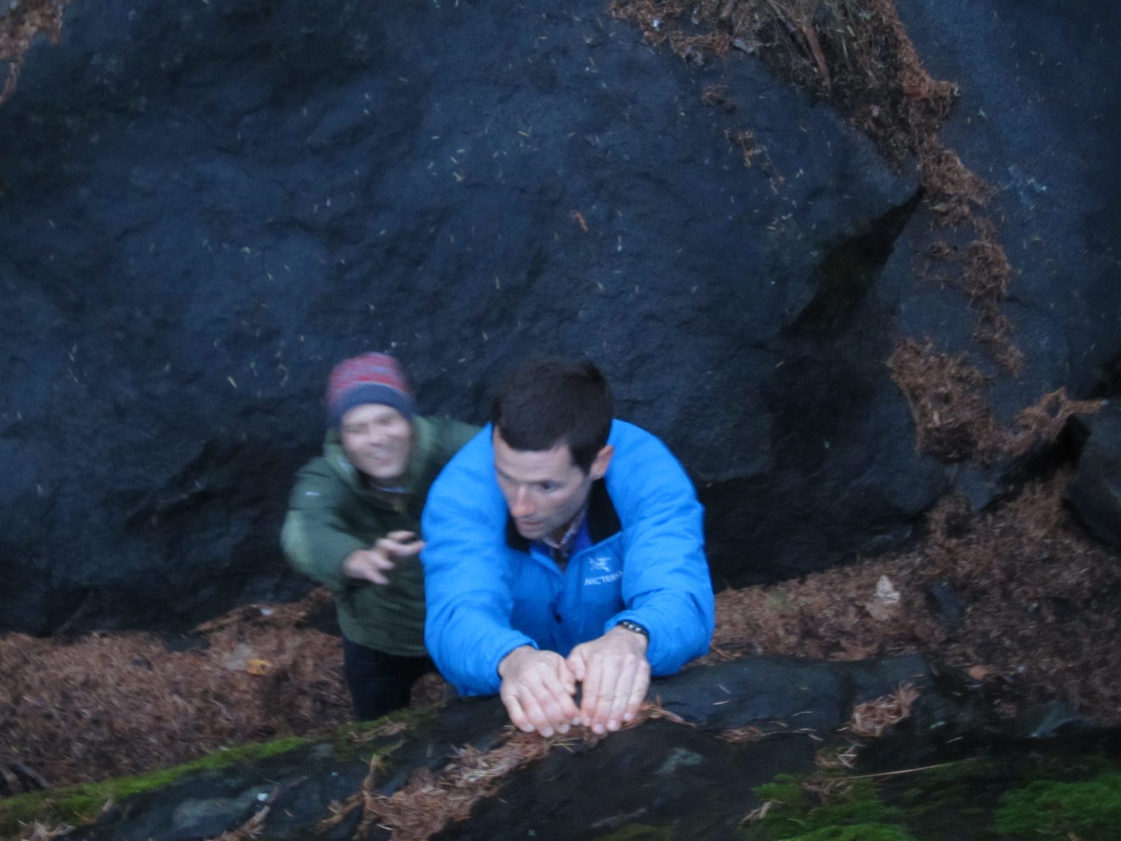 Jay looks for holds while John provides a spot.