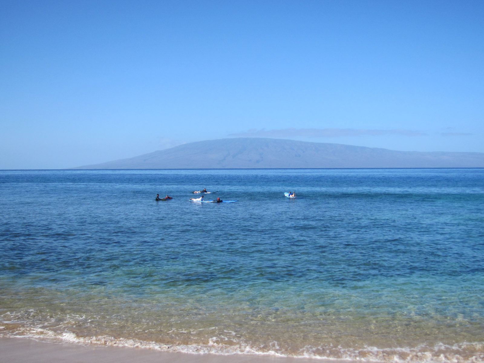 Sunday morning, I took a surfing lesson.  I'm the one all in white in the middle.  Waiting for a...