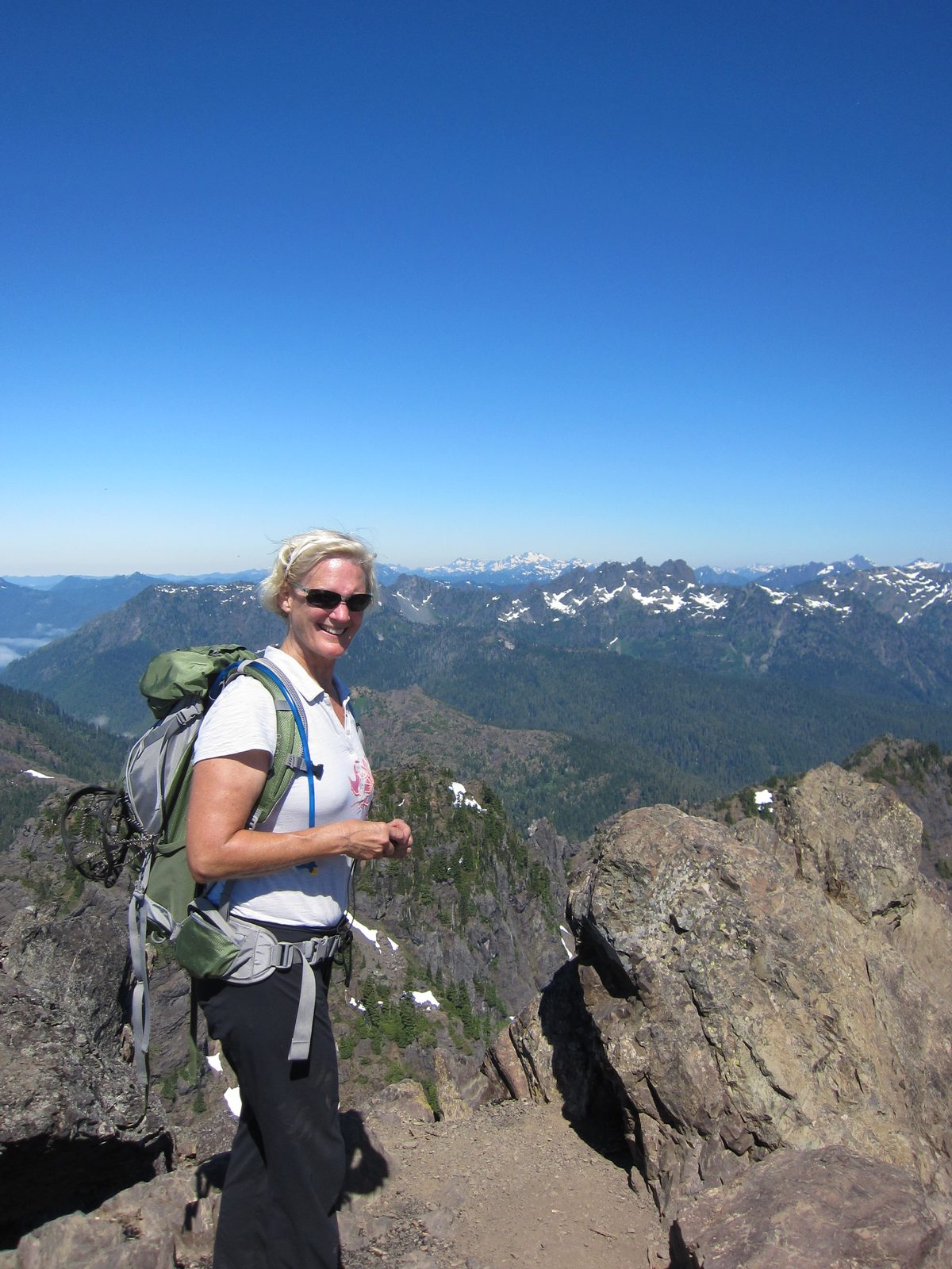 Kathie, the edge, and mountains in the distance.