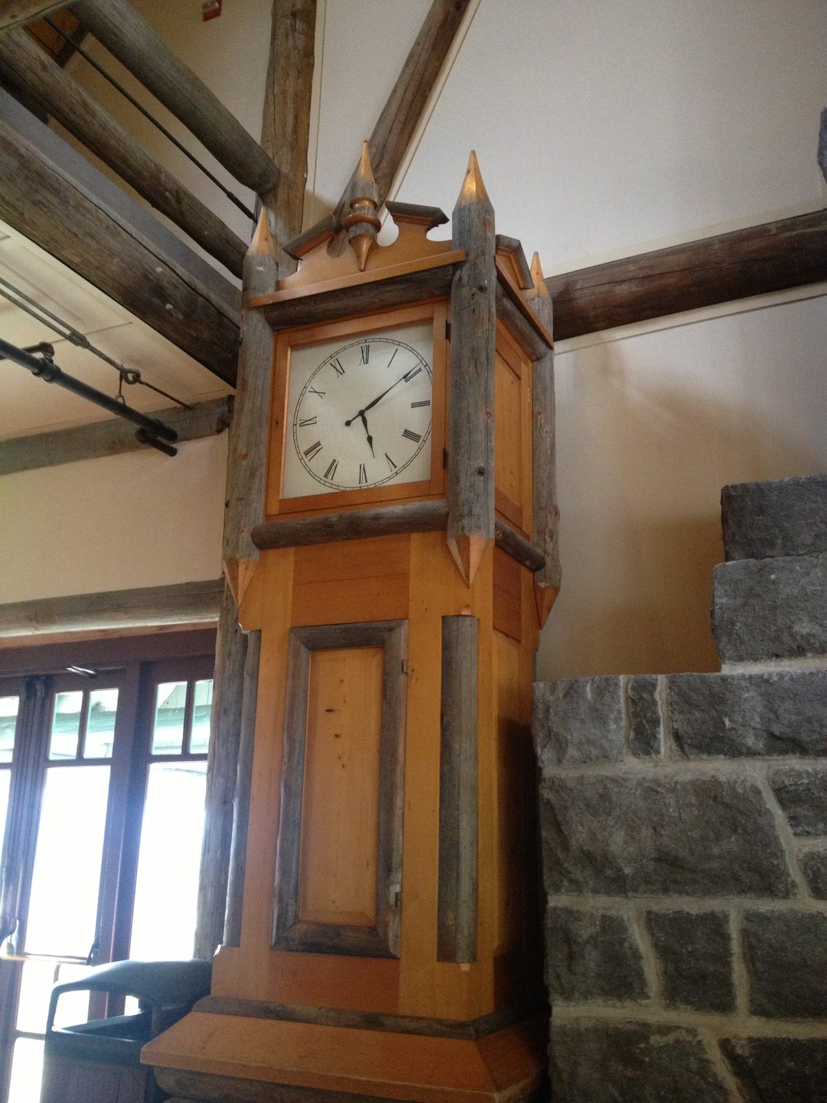 Giant grandfather clock made with log accents.