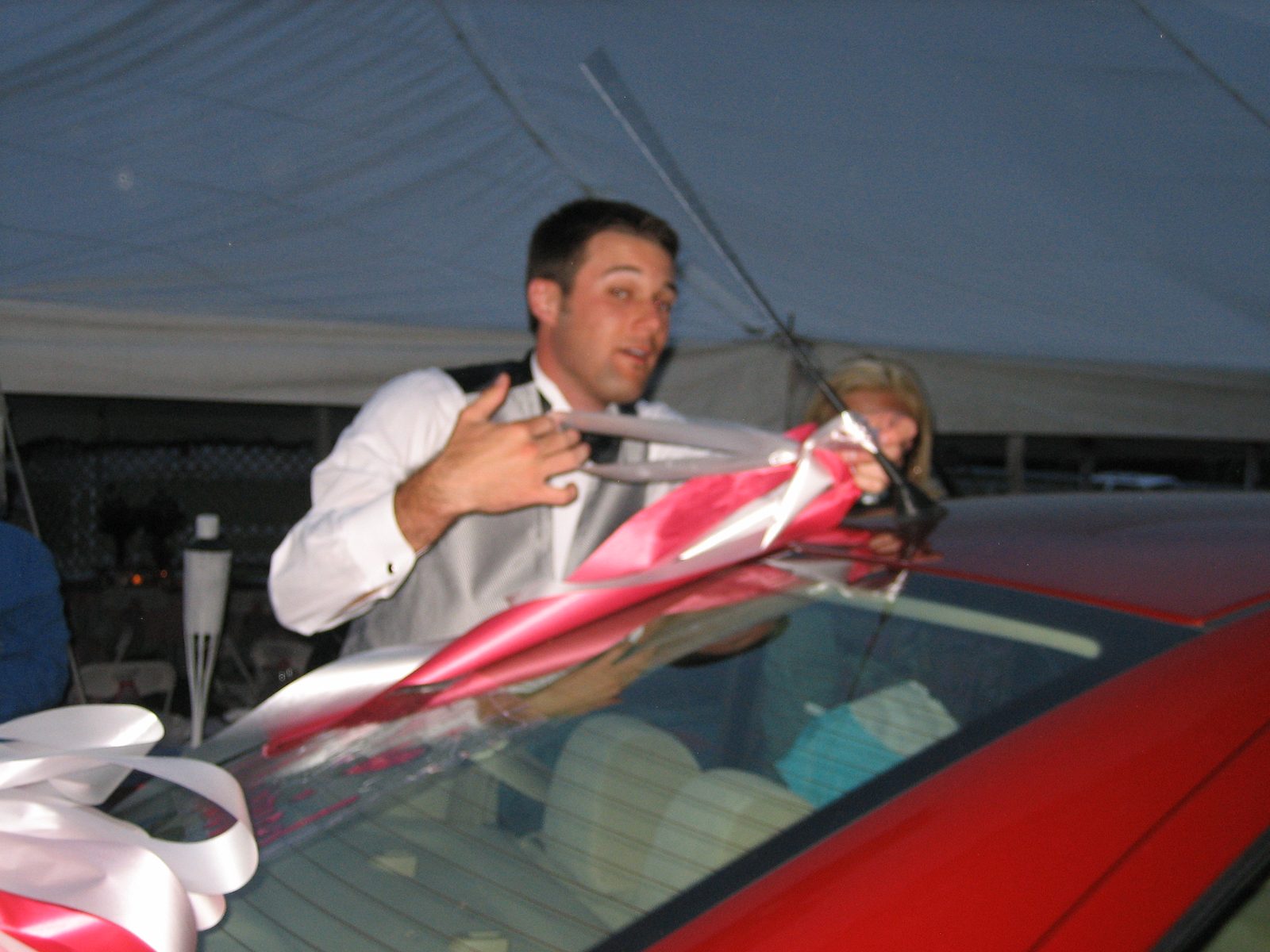 Ryan finishes the last minute decorations of the getaway car.