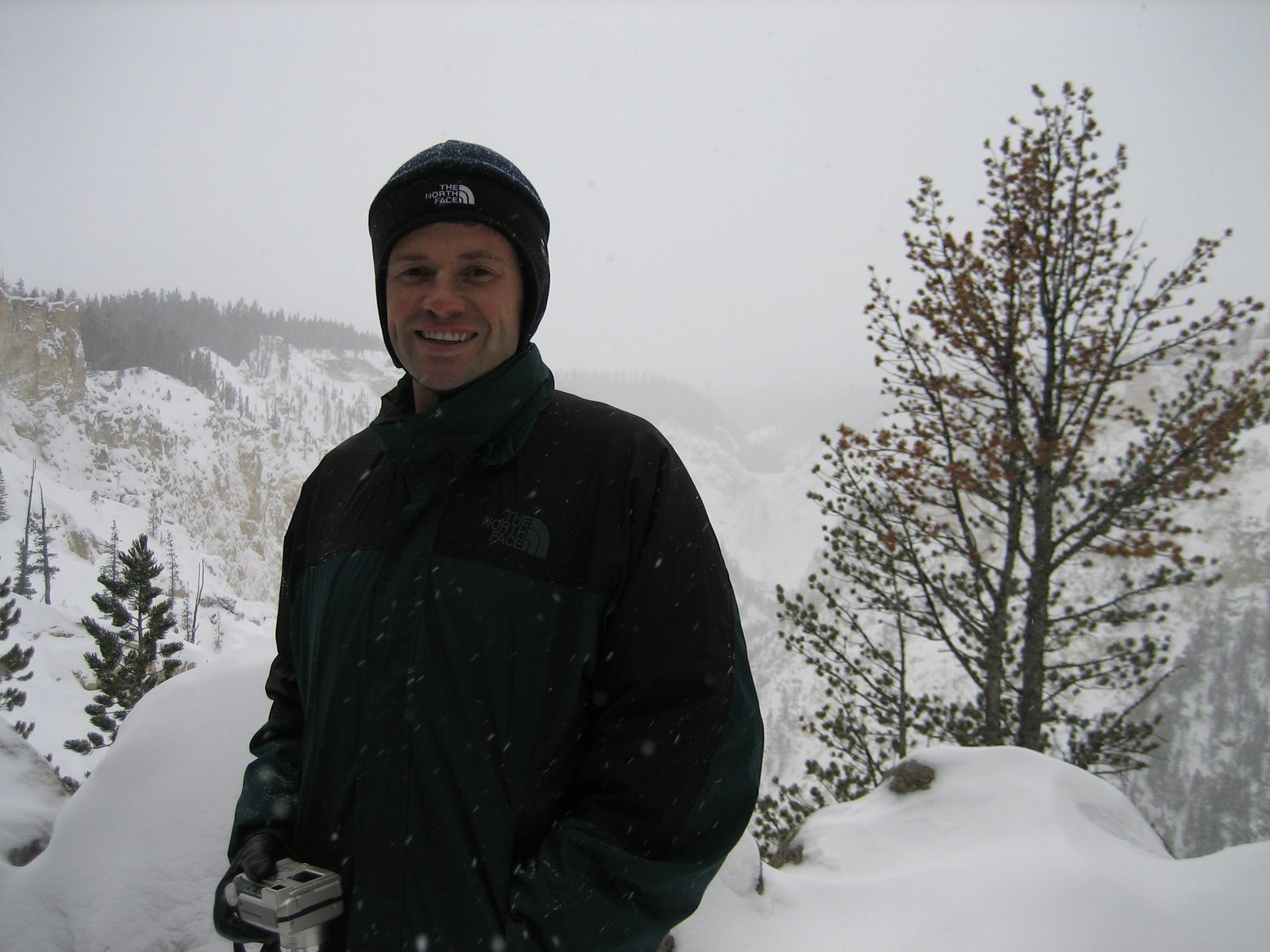 Jay tries to stay warm in front of the slighty-snowed-out scenery