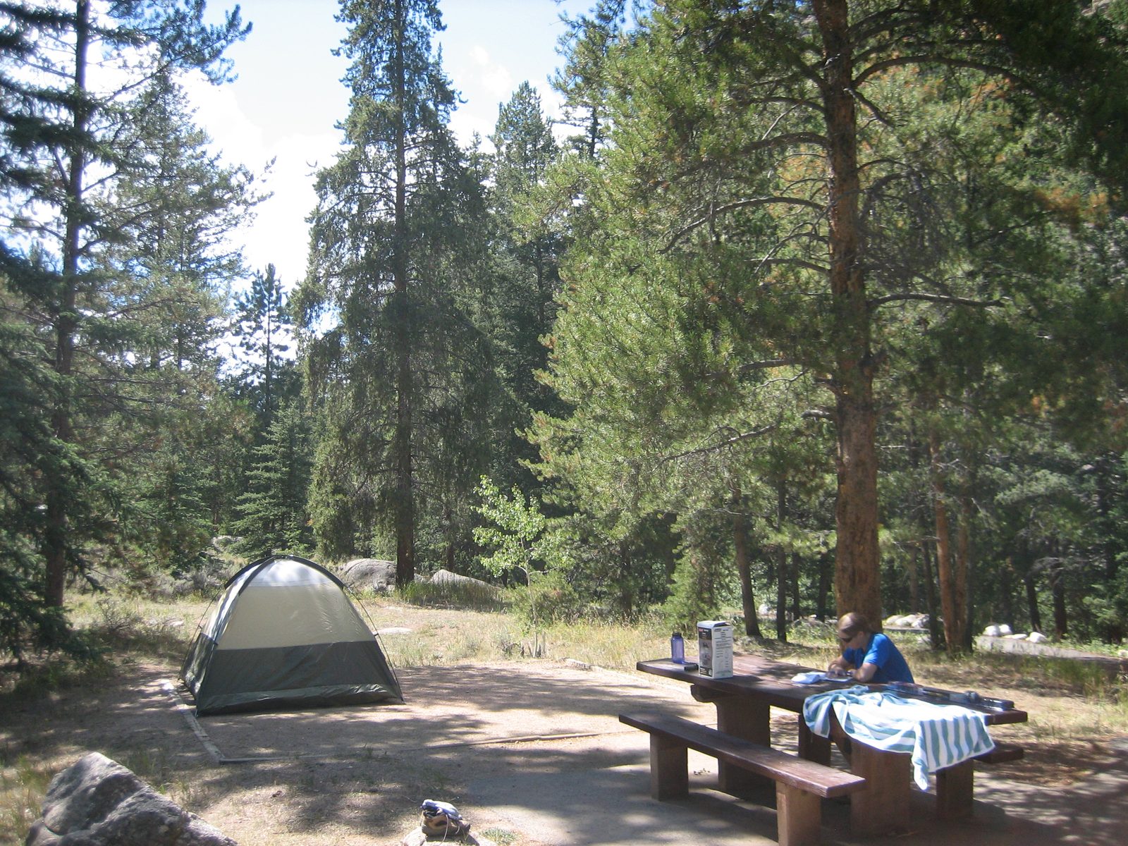 Our campsite, with Catherine working hard on a crossword