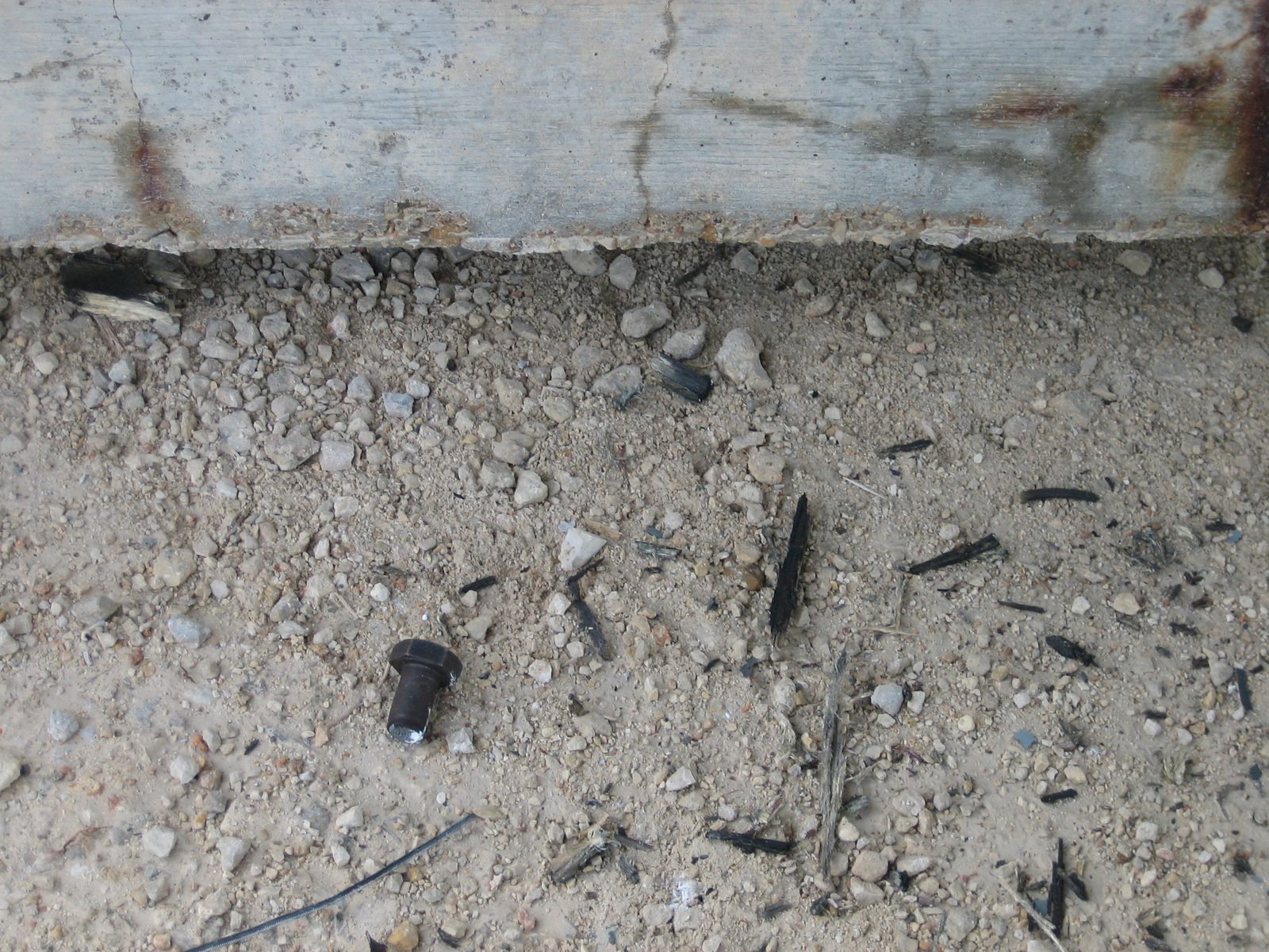 Half of the hseared bolt, next to the concrete anchor block.
