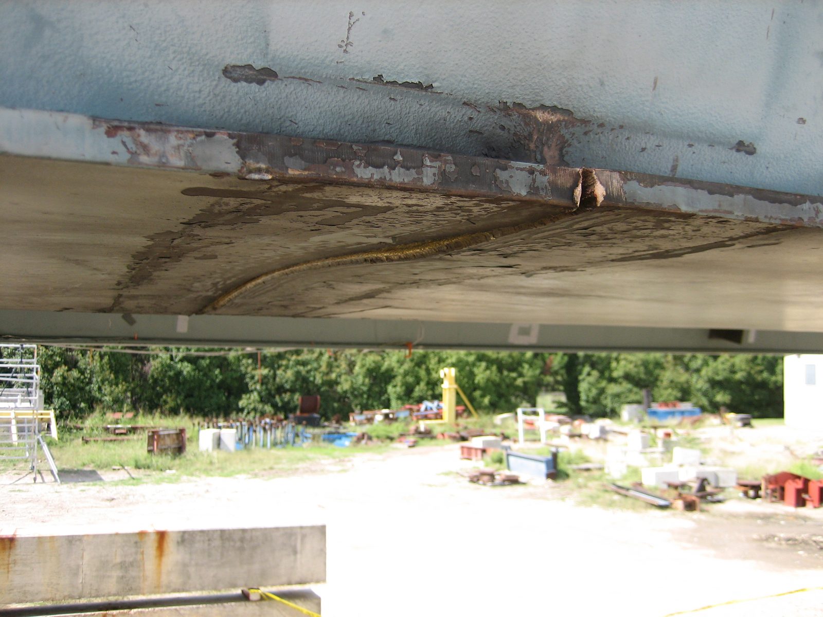 Warping of the bottom flange.