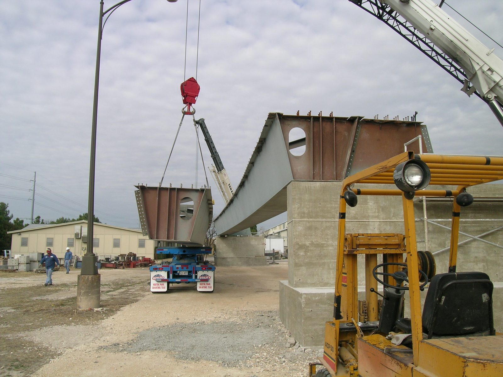 The second girder being lifted off the truck.