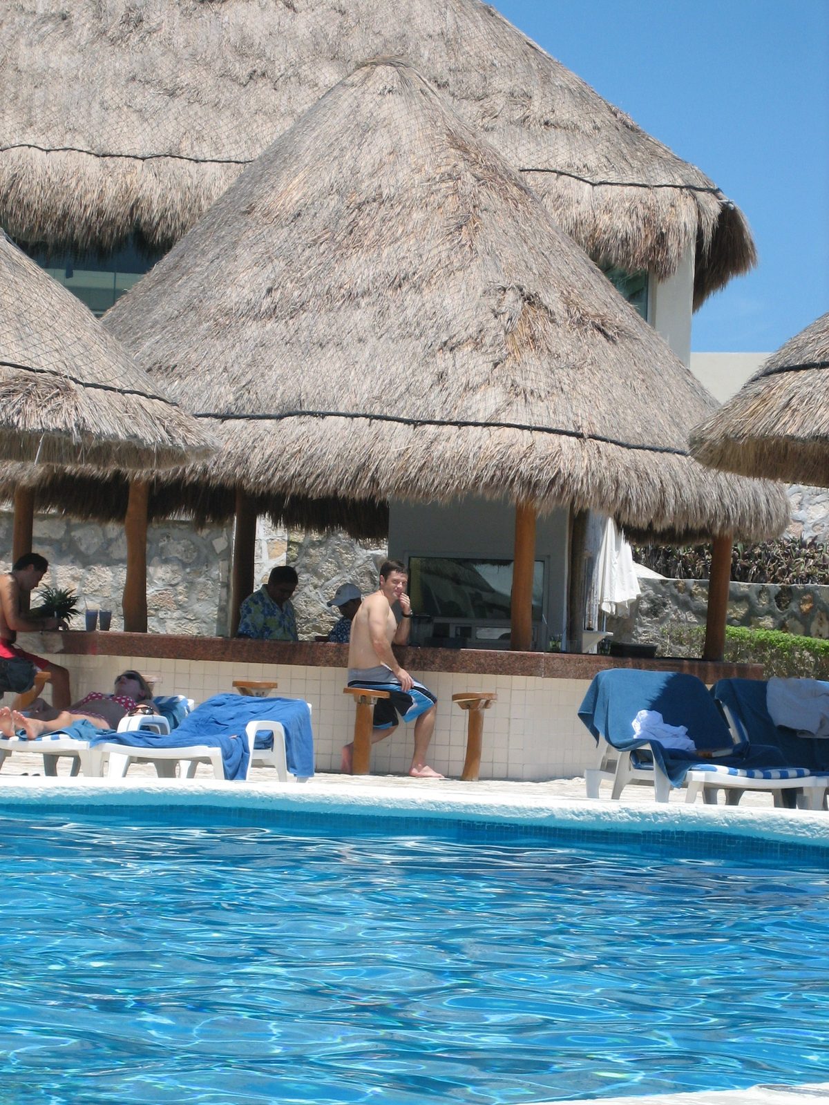 Jay at the bar by the pool, getting some drinks.  The second pool had a swim-up bar; this one...