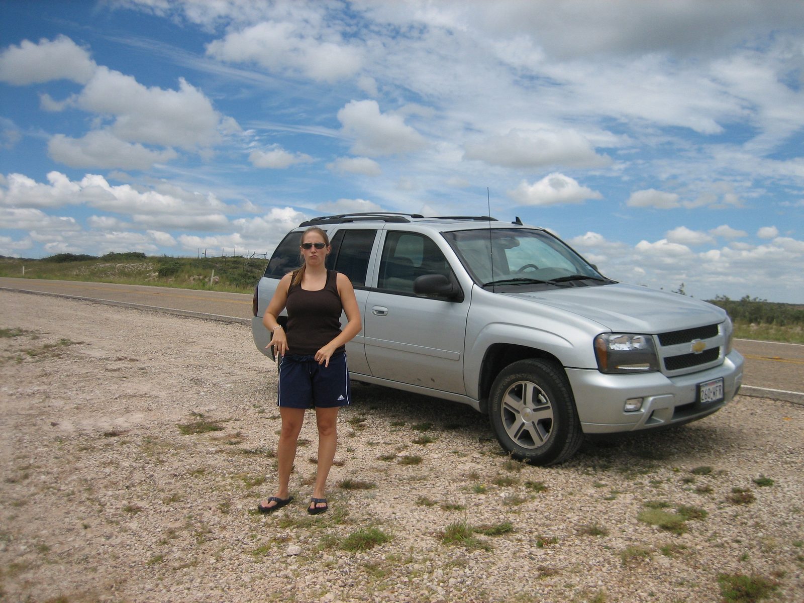 Catherine and the TrrailBlazer at a scenic overlook near CapRock Canyon.