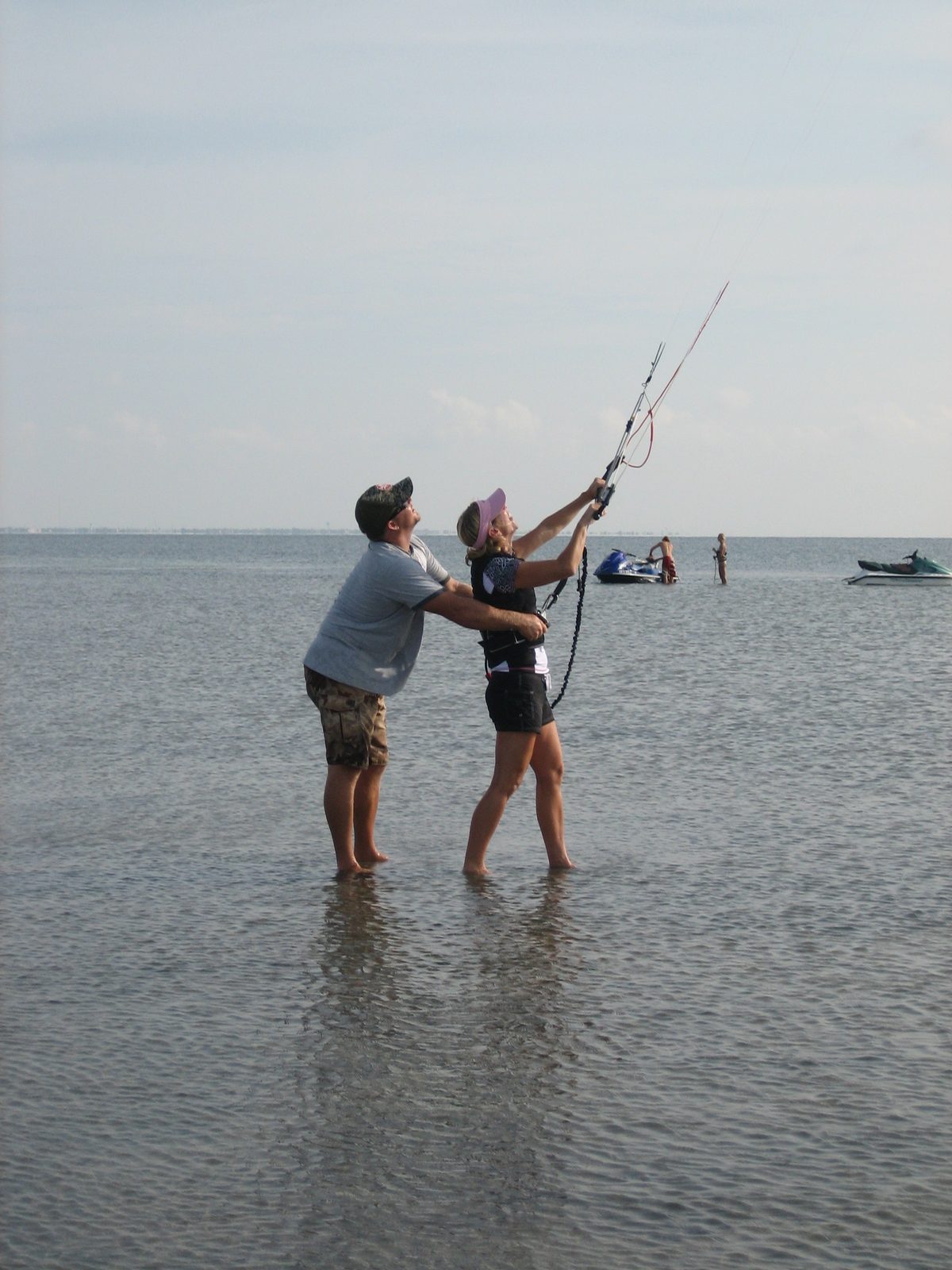 Cliff helps Jules fly the kite and/or not get dragged away.