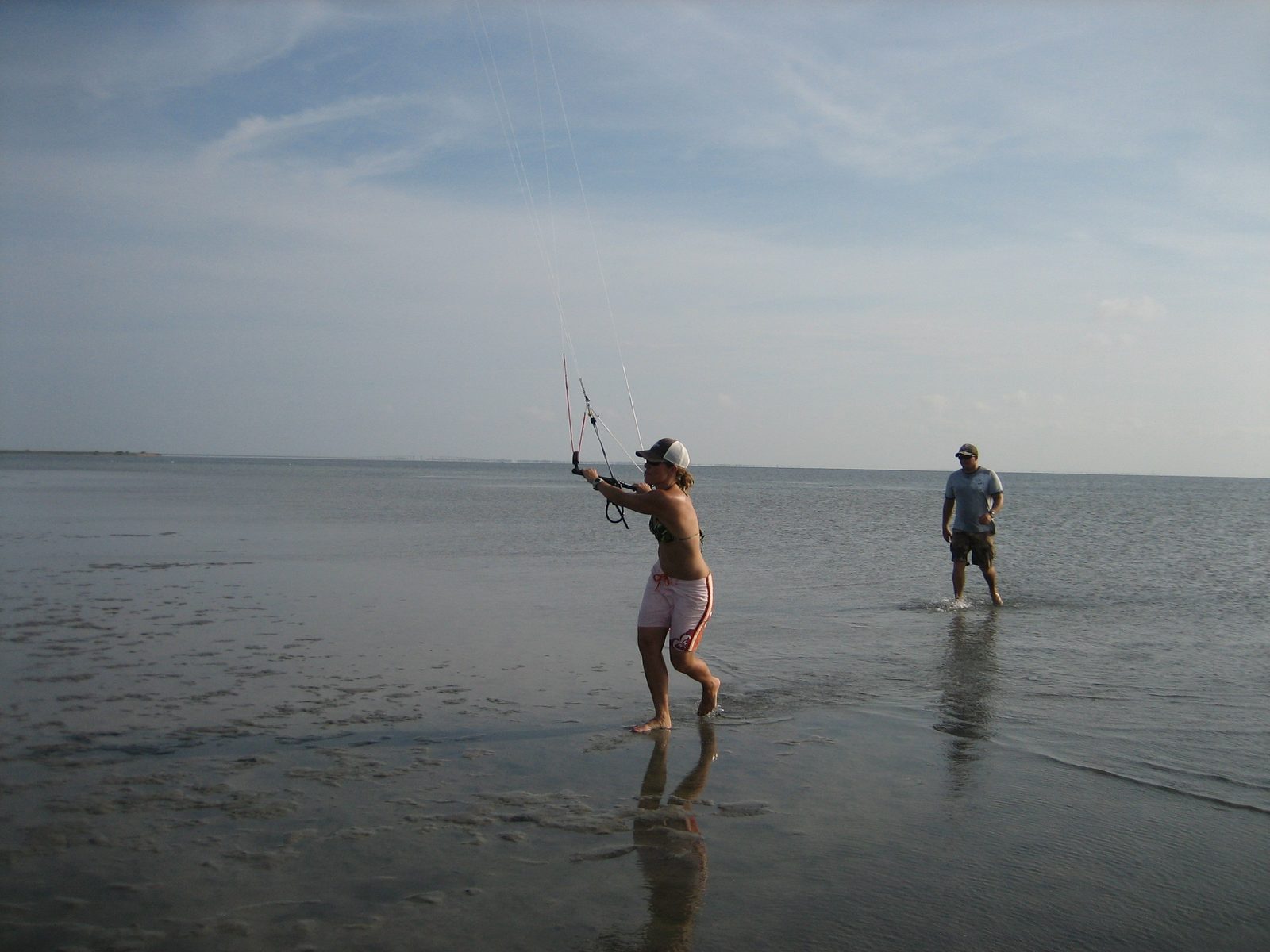 Lana flies the kite back to the cars, so as to keep it dry and clean.