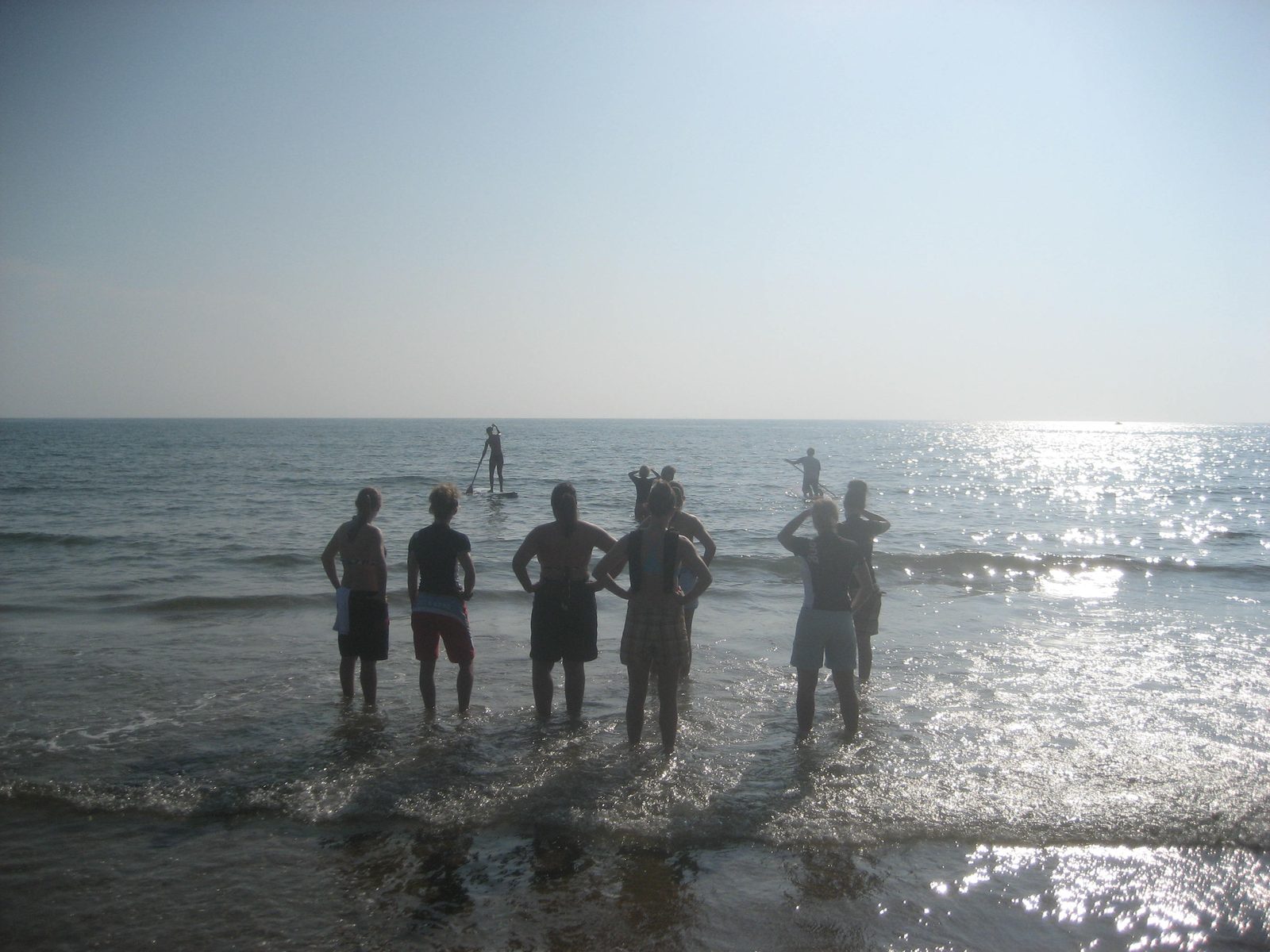 More standing on shore.