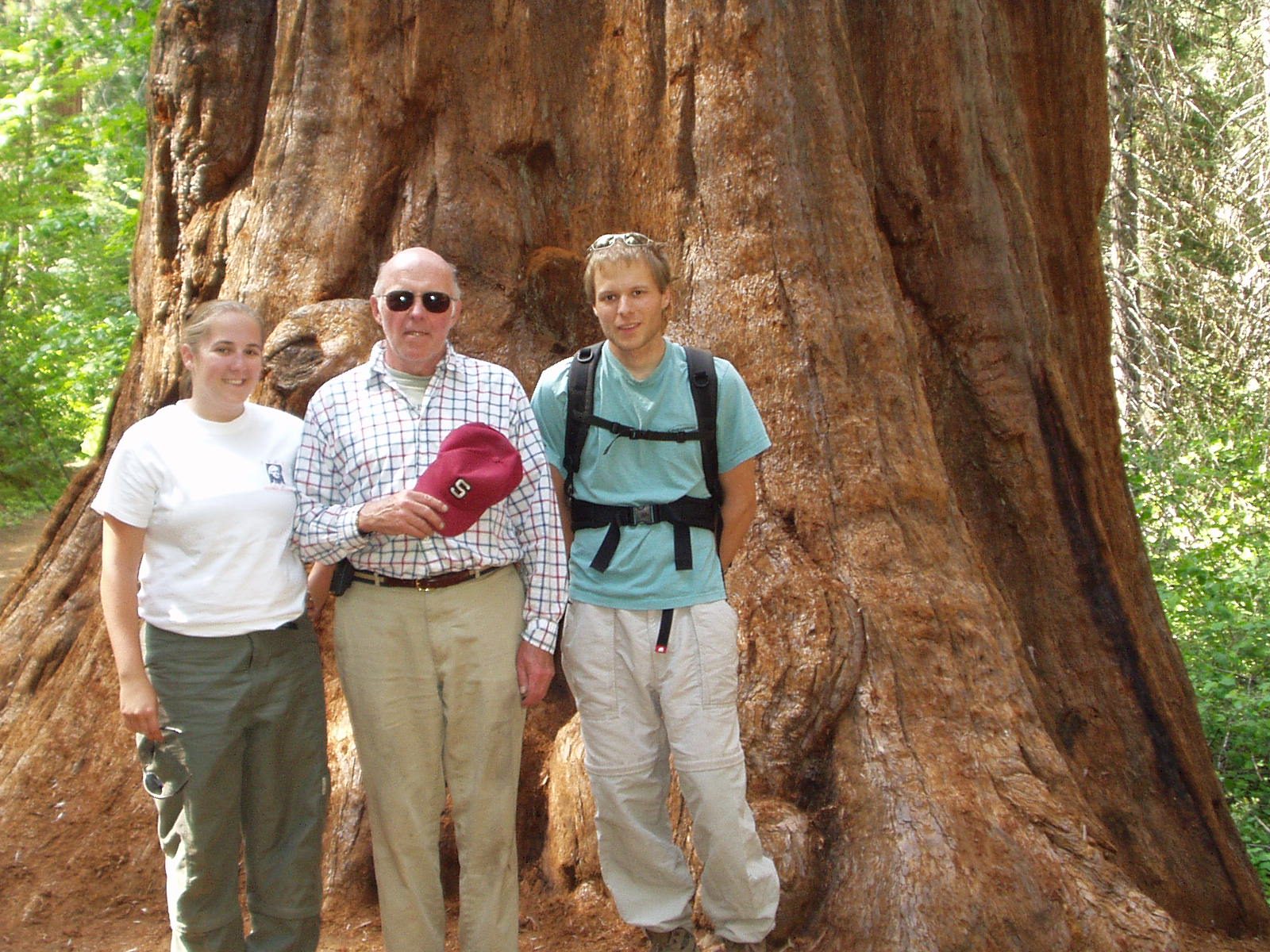 Catherine Dad and John next to a big tree in the Merced or Yosemite Grove of Giant Sequoias.