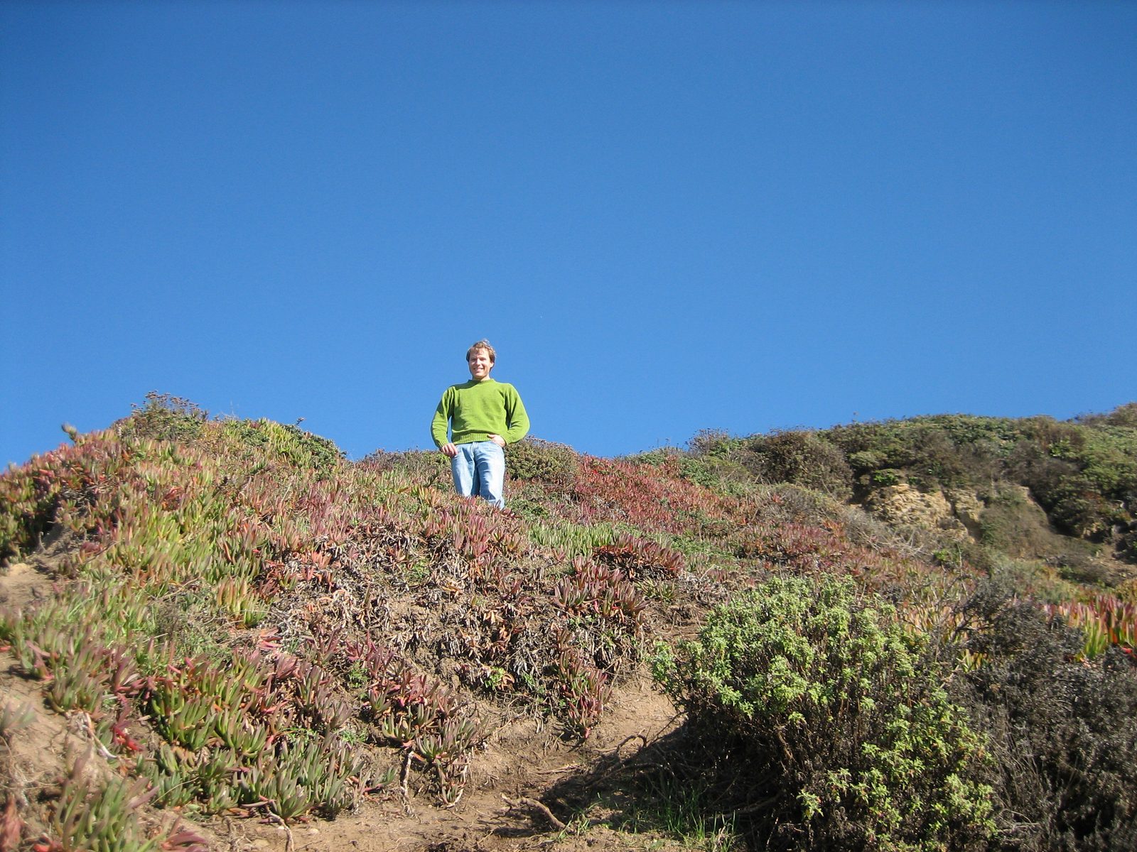John looking down on Catherine climbing down the path to the beach.  Increasing steepness...