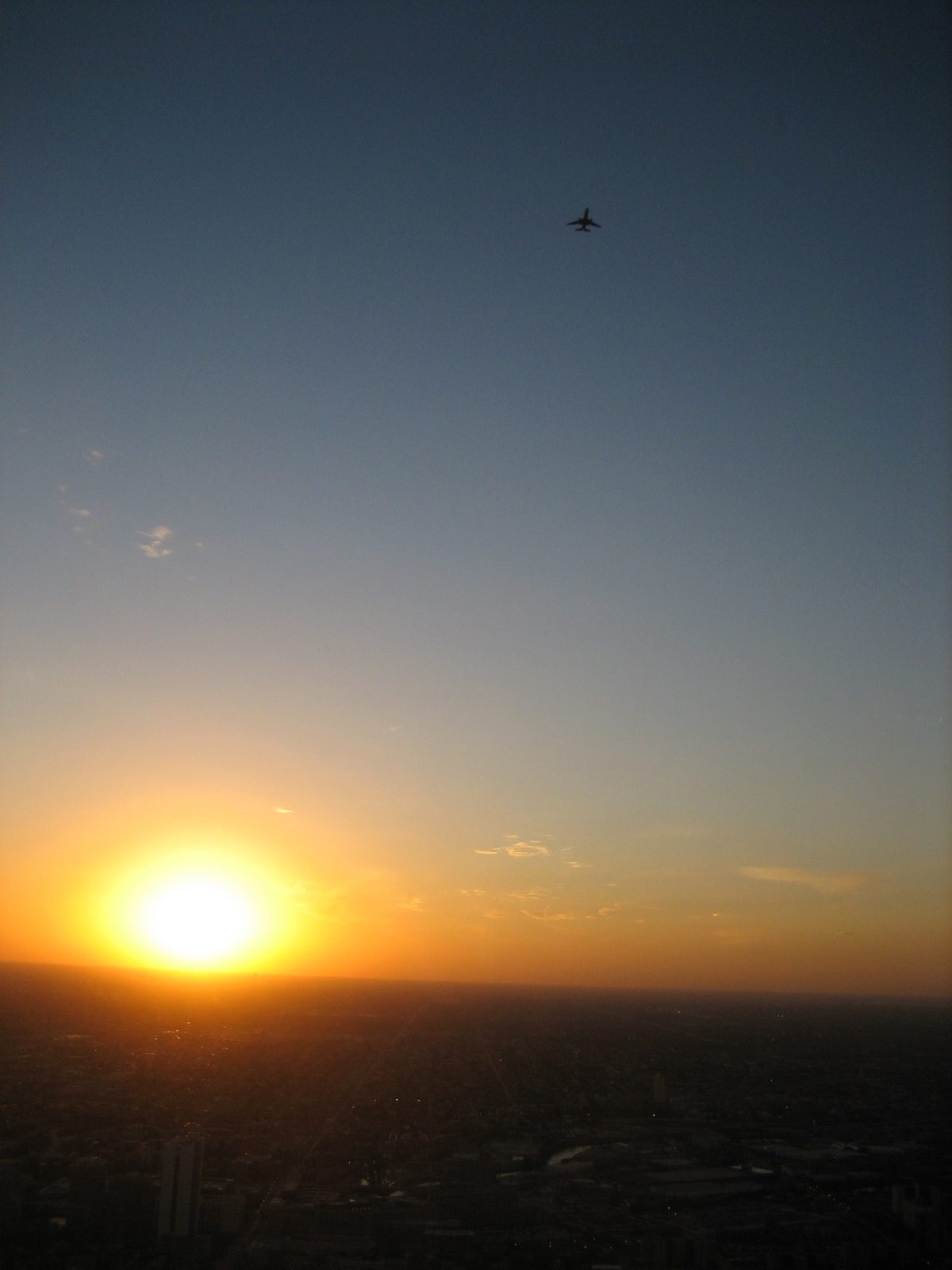 Plane flying overhead near sunset.