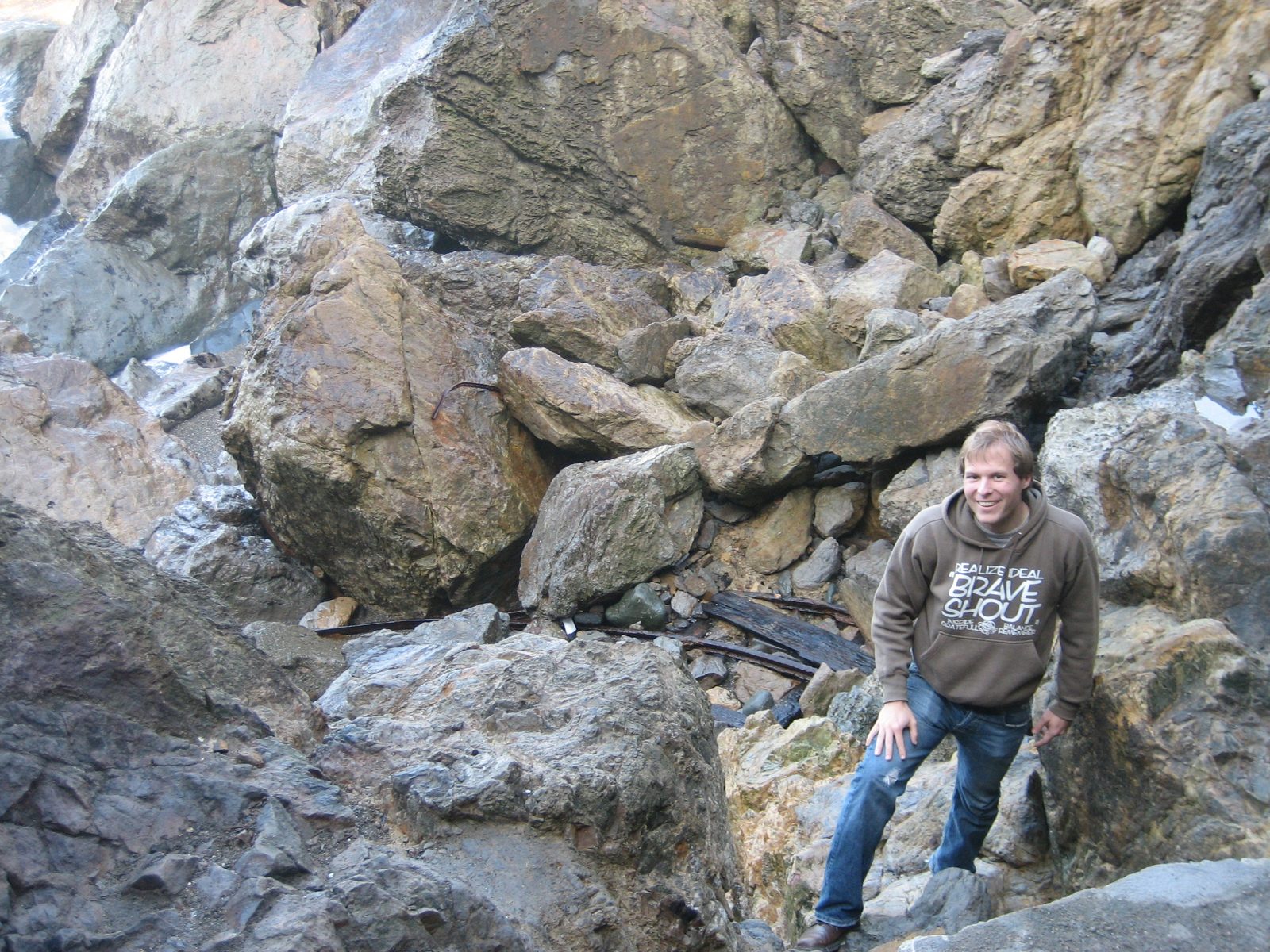 John climbs out of the damp and fortunately still not underwater gulch.