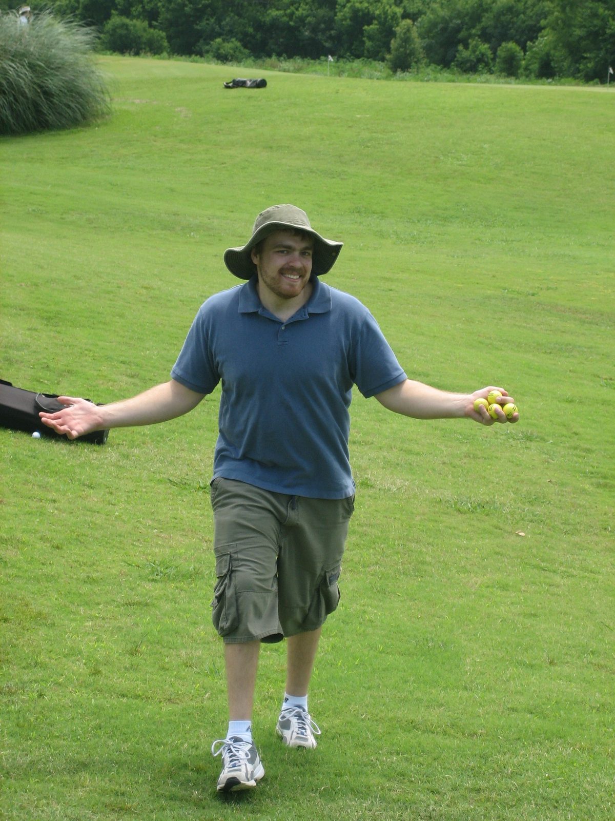 Thomas collects himself some range balls.
