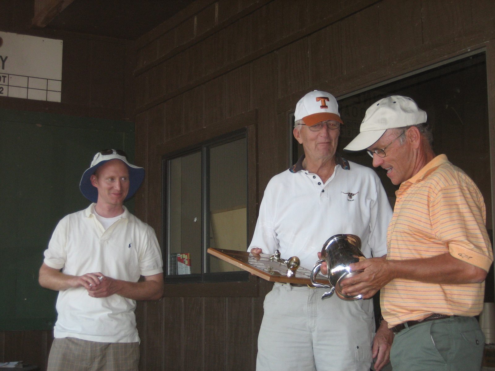 Dr. Breen gives the winners their trophy, while Master Organizer Daniel looks on.