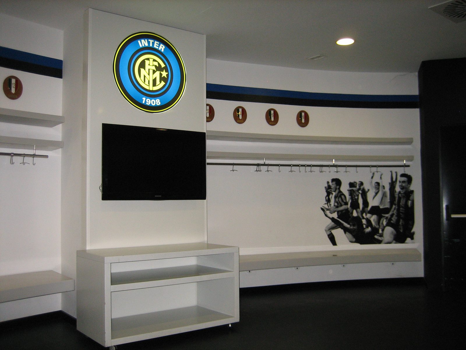The FC Inter locker room.  Note: bench, shared clothes-hanger bar, simple design.  Keep those in mind.