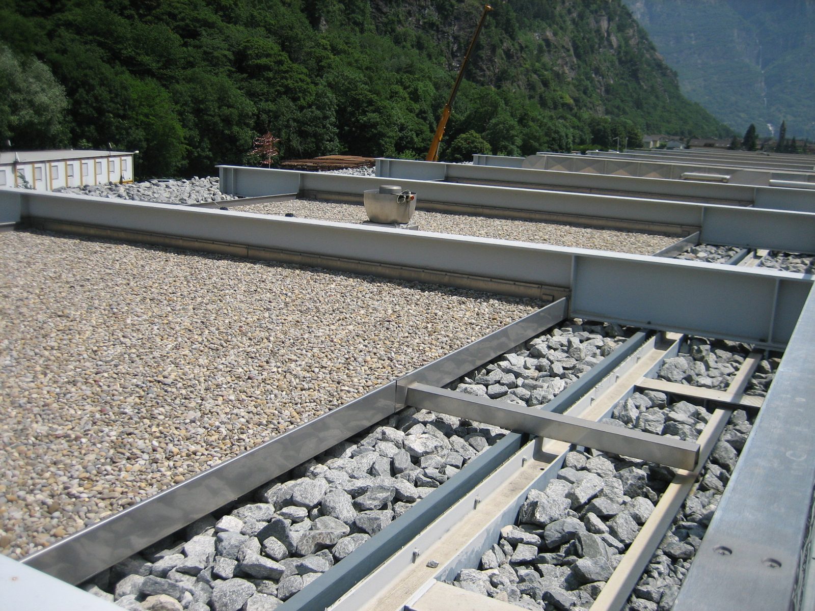 The roof of the building.  The rock walls are in the right foreground, the beams spanning to the left.