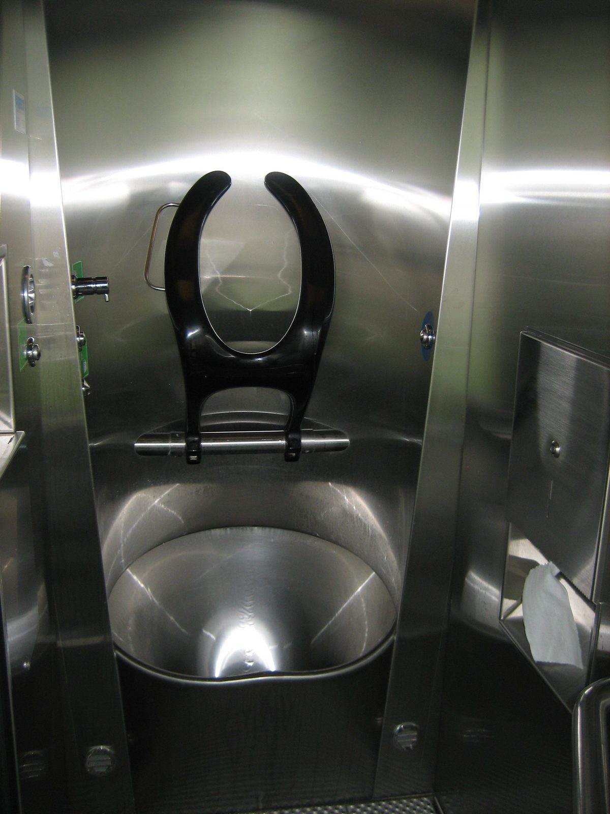 With the craziest toilet contraption I have ever seen inside.  Note that the seat is...